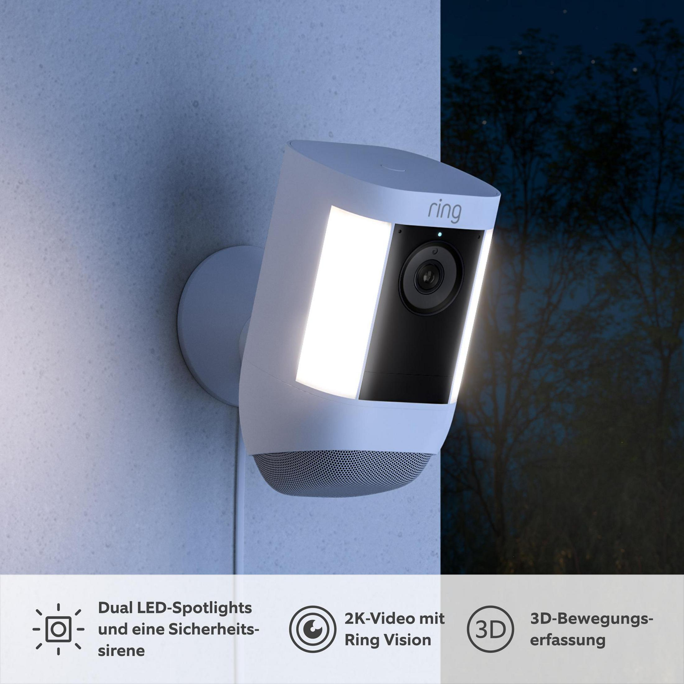Weiße Sicherheitskamera mit hellen LED-Strahlern und dunklem Nachthintergrund.