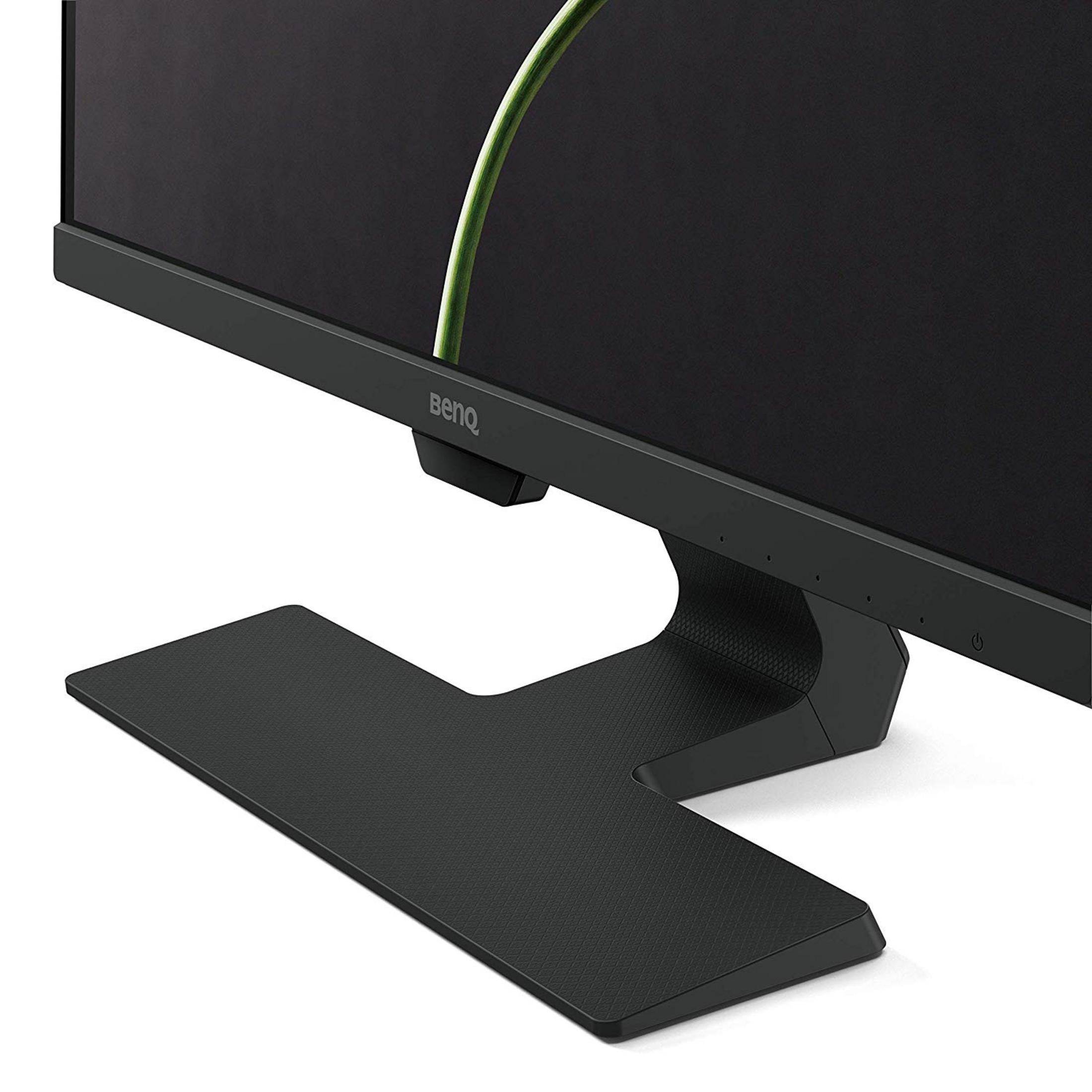 Un monitor BenQ negro con base texturizada y una hoja verde de fondo.