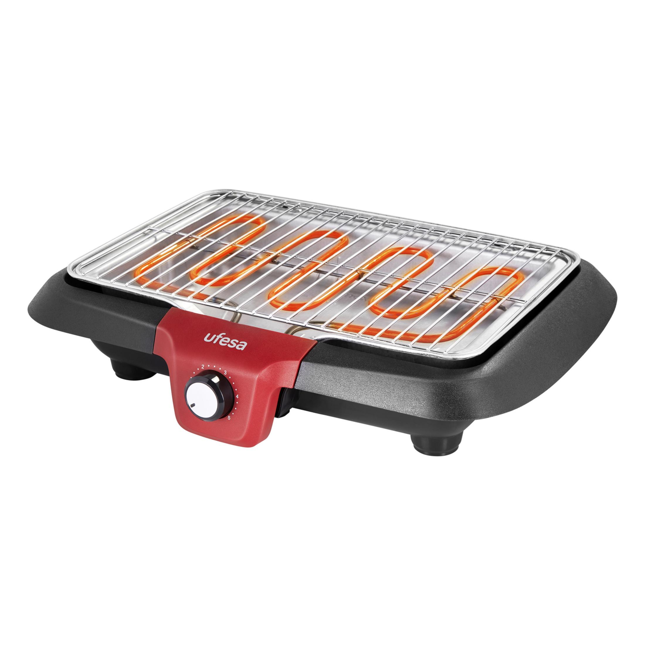 Una parrilla eléctrica de mesa con rejilla cromada y elementos calefactores rojos.