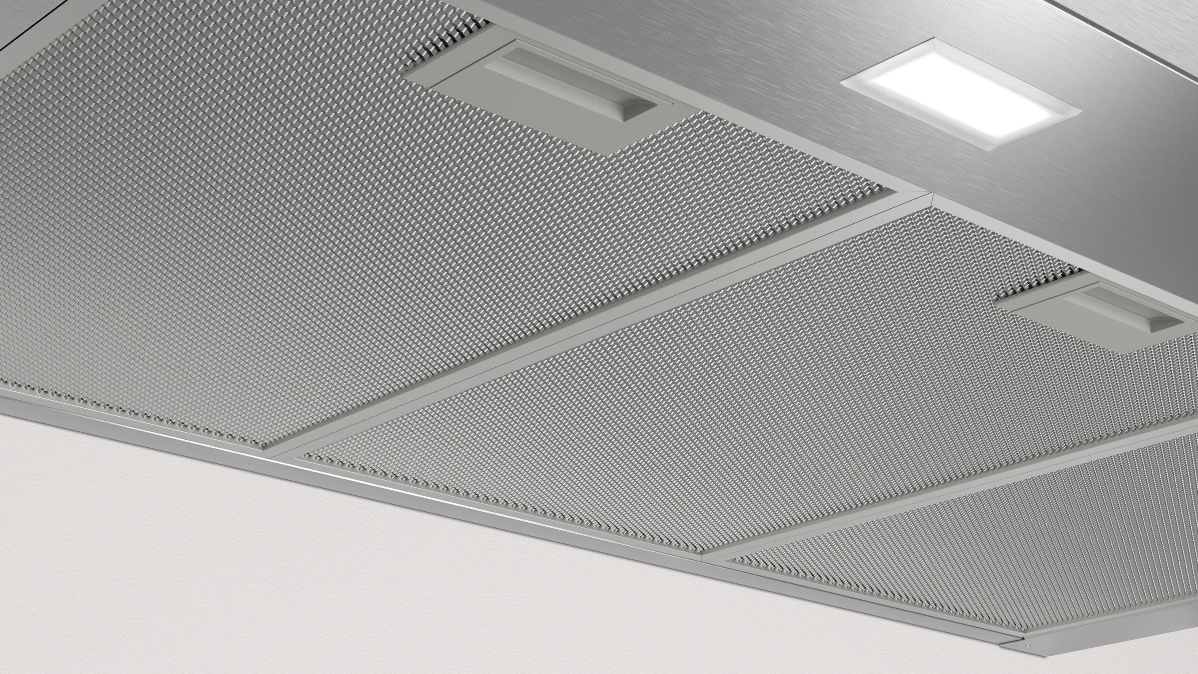 Filtro cappa aspirante metallico con luce LED e pannelli a rete.