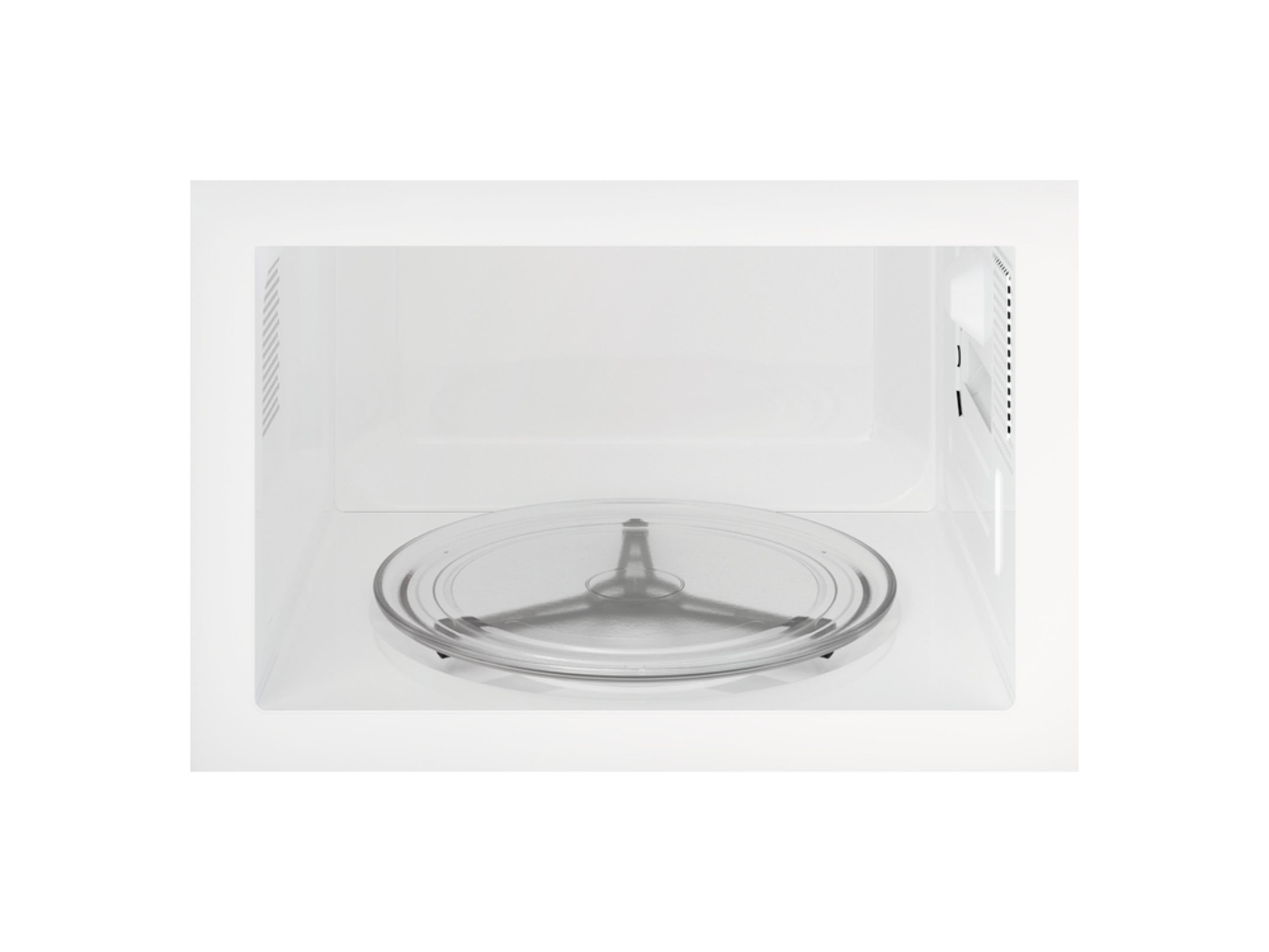 Interior vacío de microondas blanco con plato giratorio de cristal.