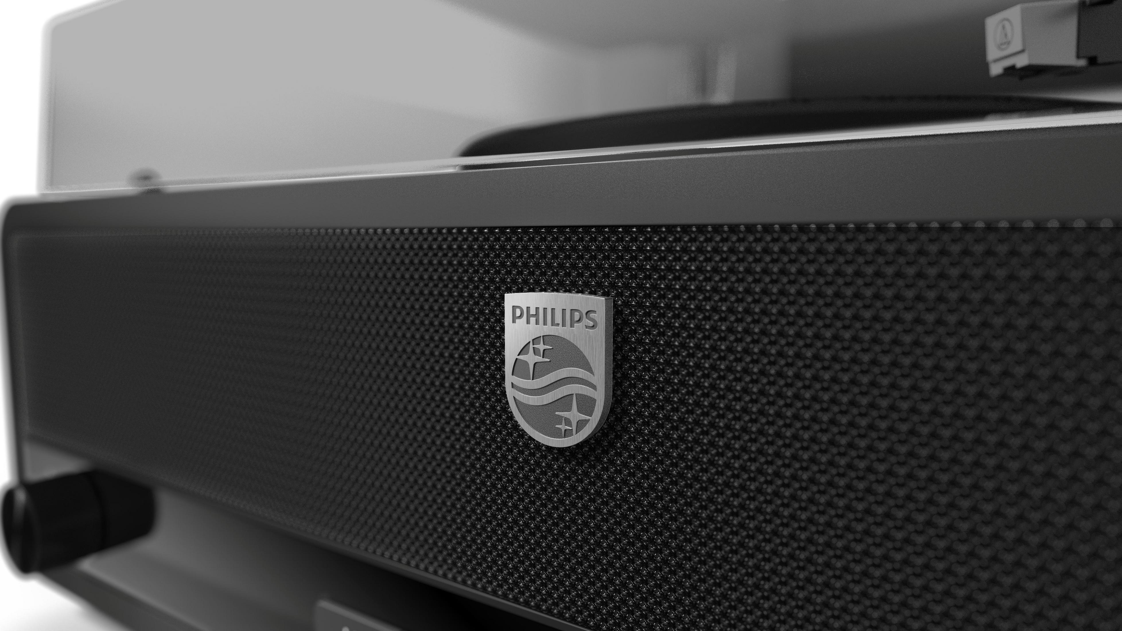Schwarzer Lautsprecher mit Philips-Logo und Drehscheibe im Hintergrund.