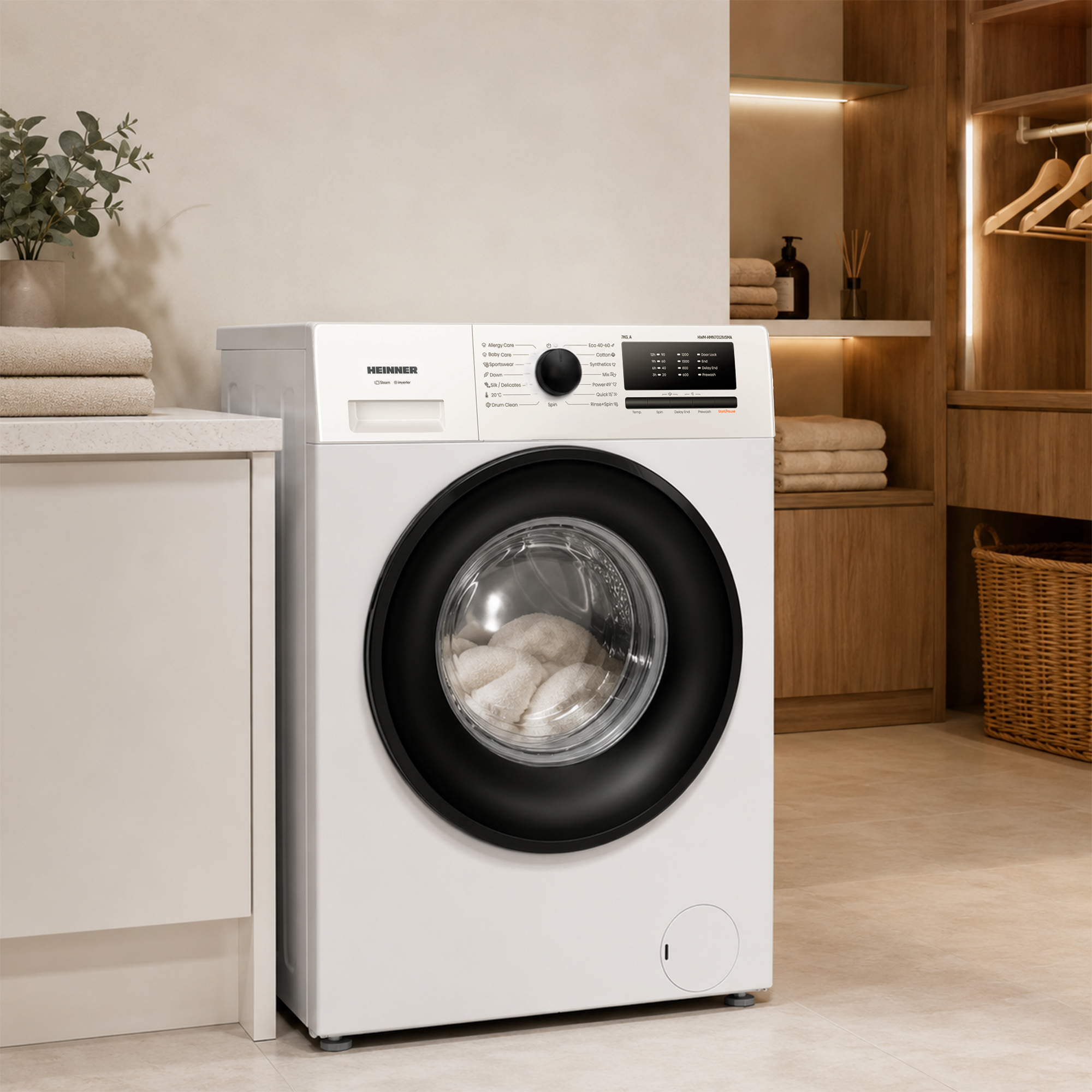 A white Heinner washing machine with a black door, loaded with white towels.