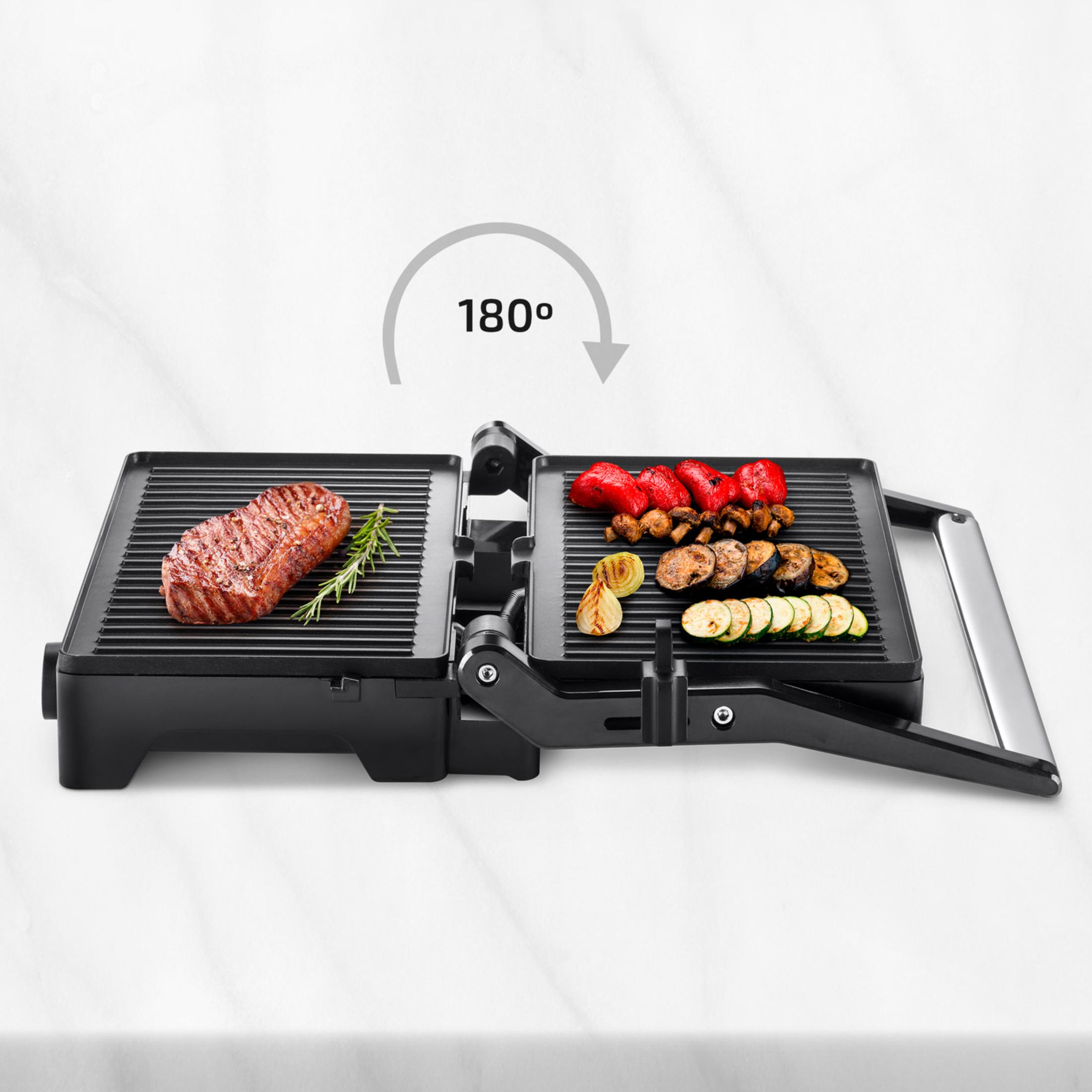 Una parrilla abierta con un filete y verduras, símbolo de 180 grados.