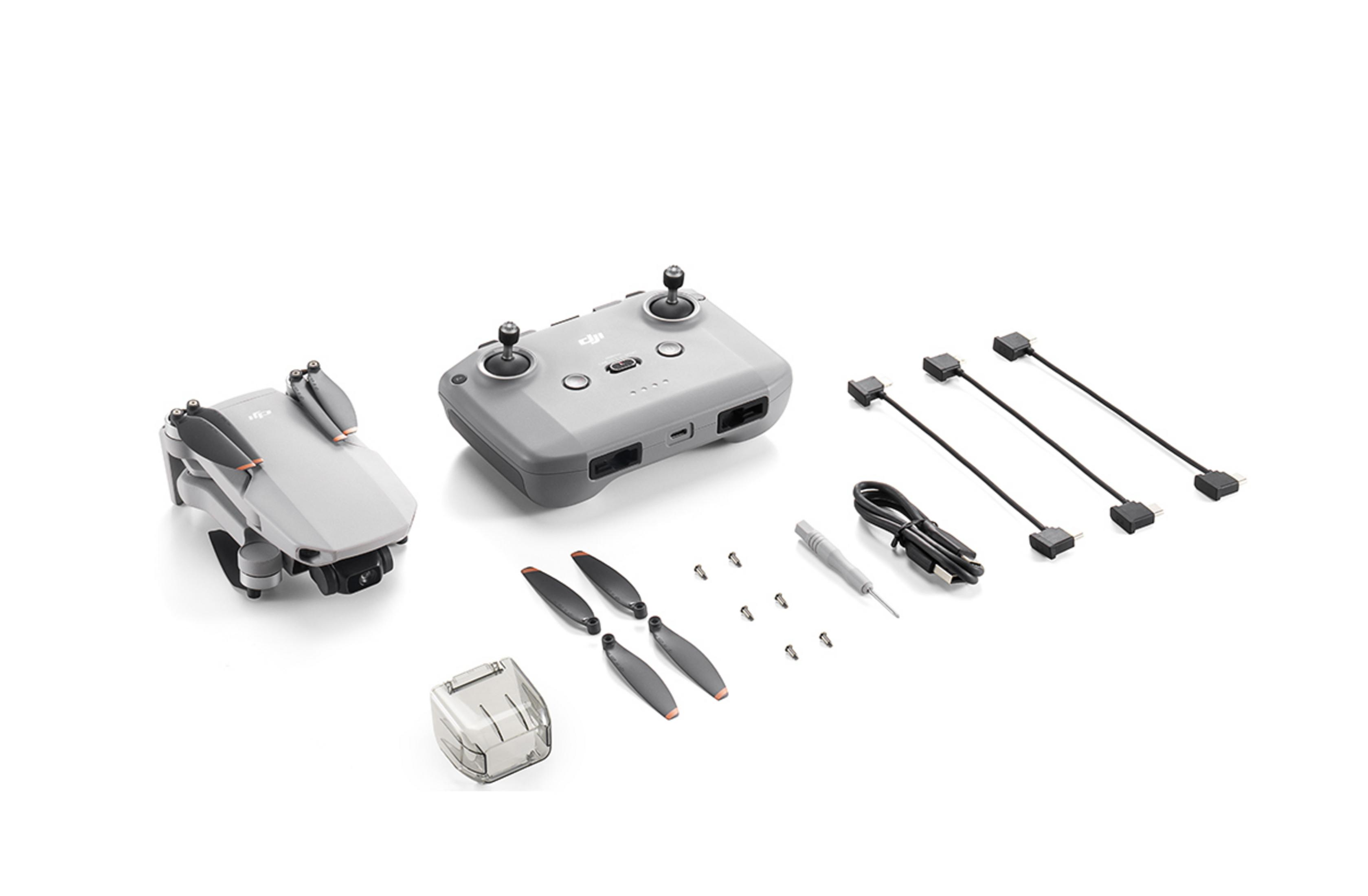 Gri drone kiti, drone, uzaktan kumanda, pervaneler ve kablolar içerir.