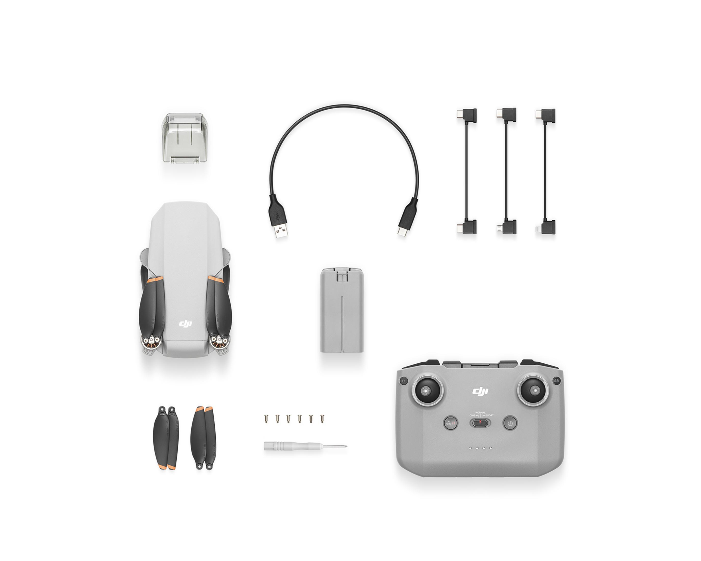 Gri DJI Mini drone kiti uzaktan kumanda, yedek pervaneler, kablolar ve tornavida ile.