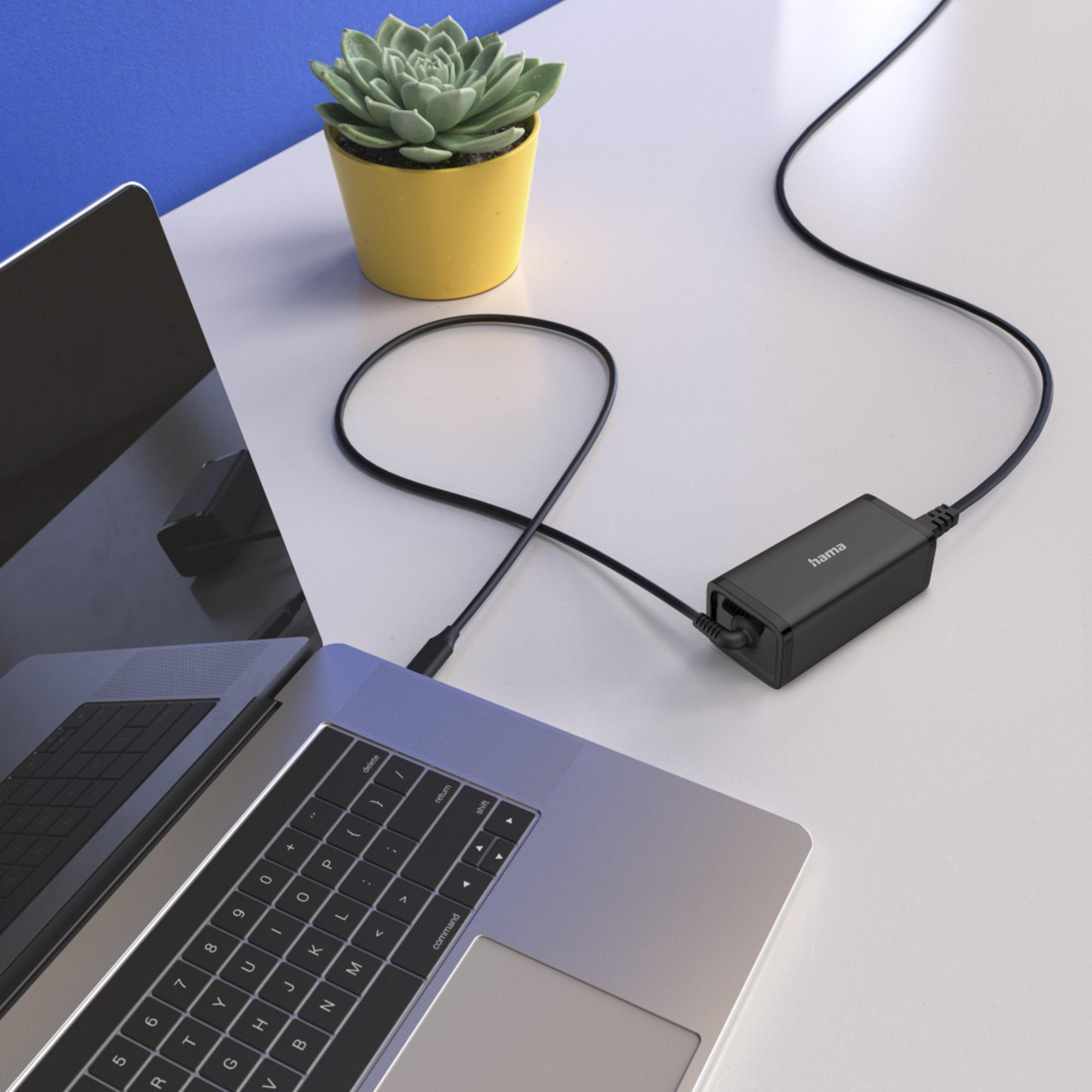 Laptop mit Hama-Netzteil, Kabel und Topfpflanze auf weißem Schreibtisch.