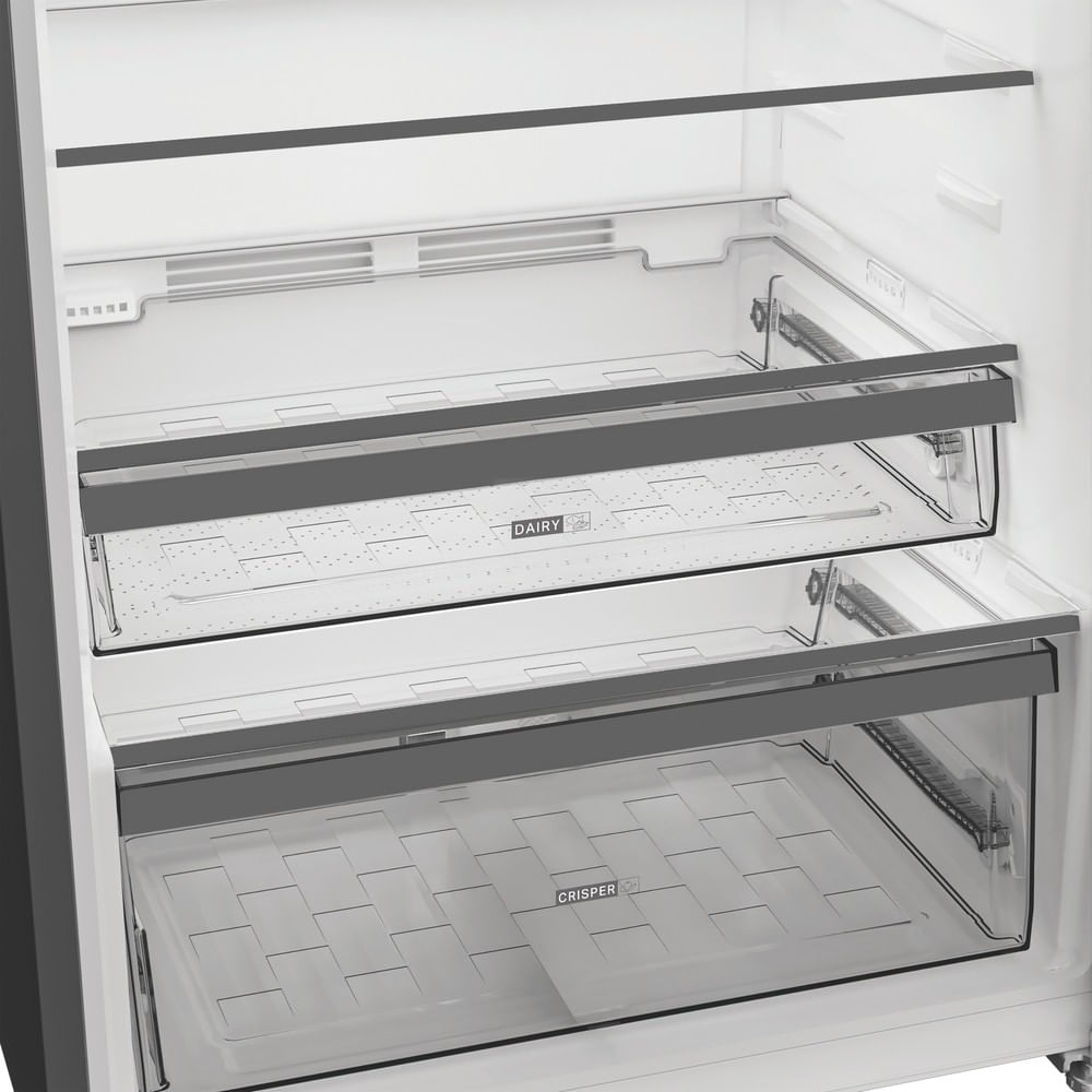 Interior view of a refrigerator with two clear drawers labeled DAIRY and CRISPER.
