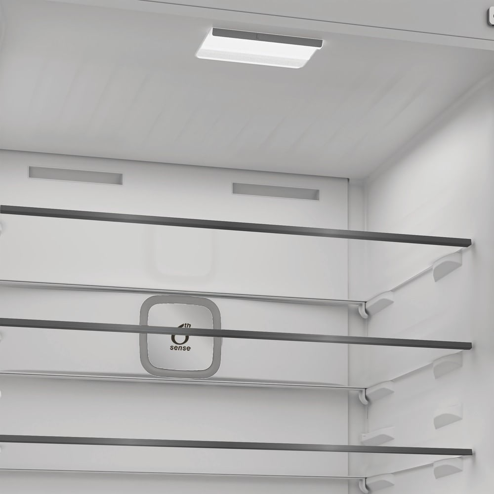 Interior of a clean, empty white refrigerator with glass shelves and a light.