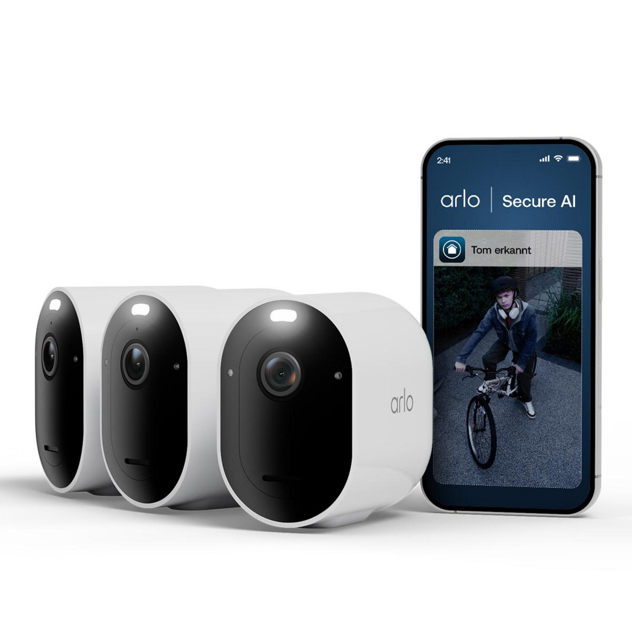 Tre telecamere Arlo bianche accanto a uno smartphone che mostra un video.