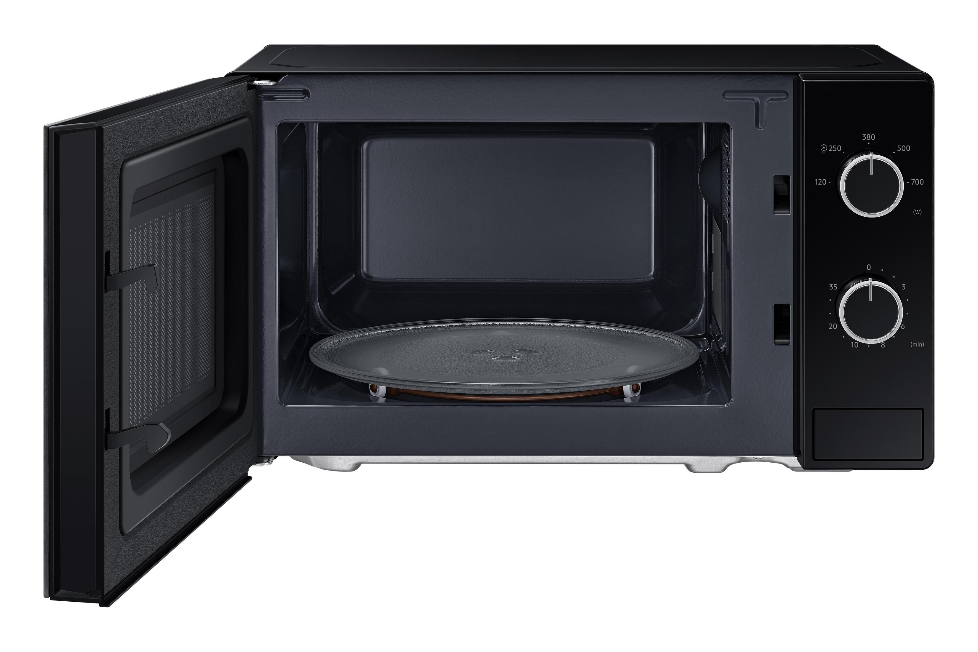Micro-ondes noir avec porte ouverte et plateau tournant à l'intérieur.