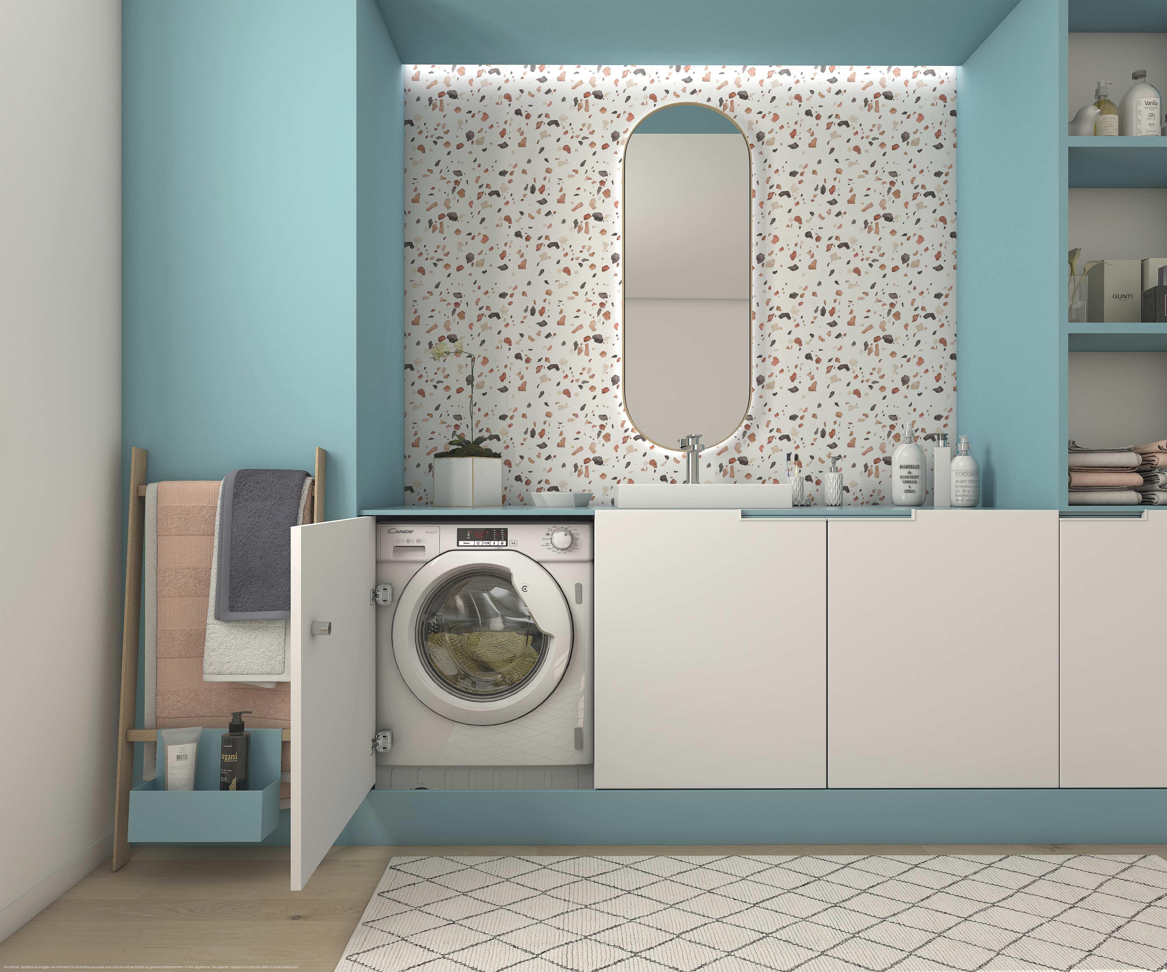 Un bagno con lavatrice, lavandino, specchio e asciugamani.