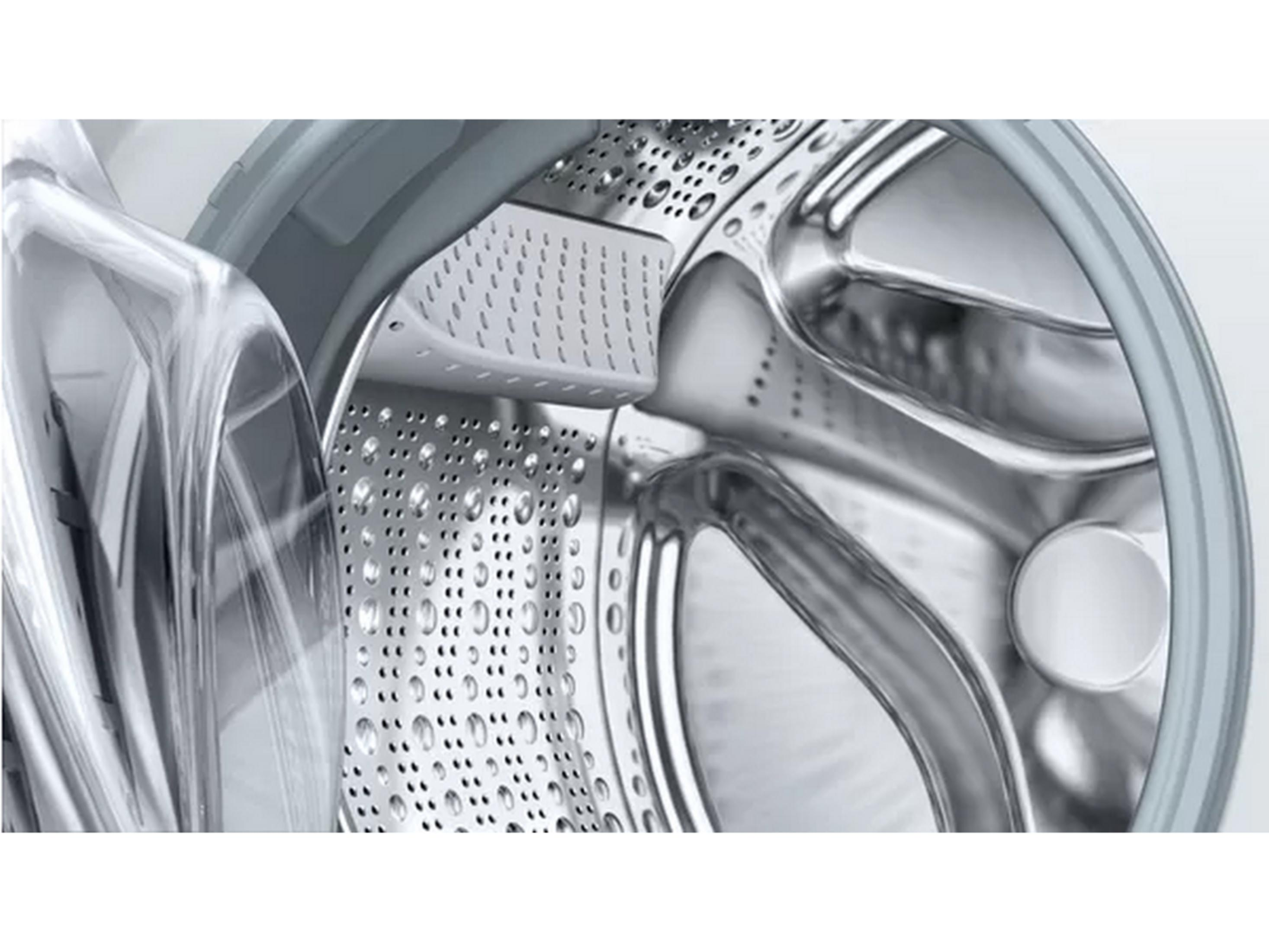 Detailansicht der Trommel einer Waschmaschine mit Wasserstrahlen.
