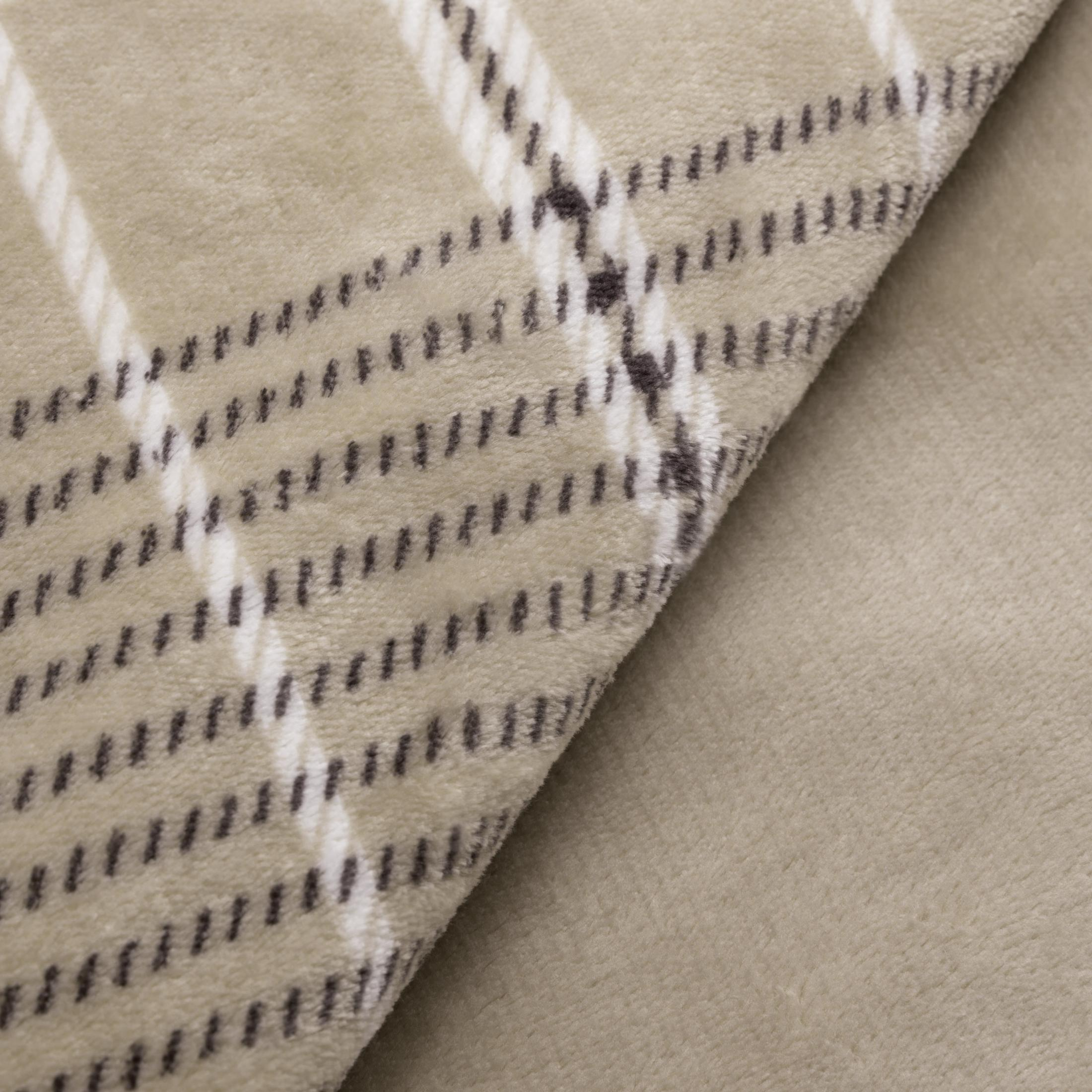 Tejido beige con patrón a cuadros de líneas blancas y oscuras.