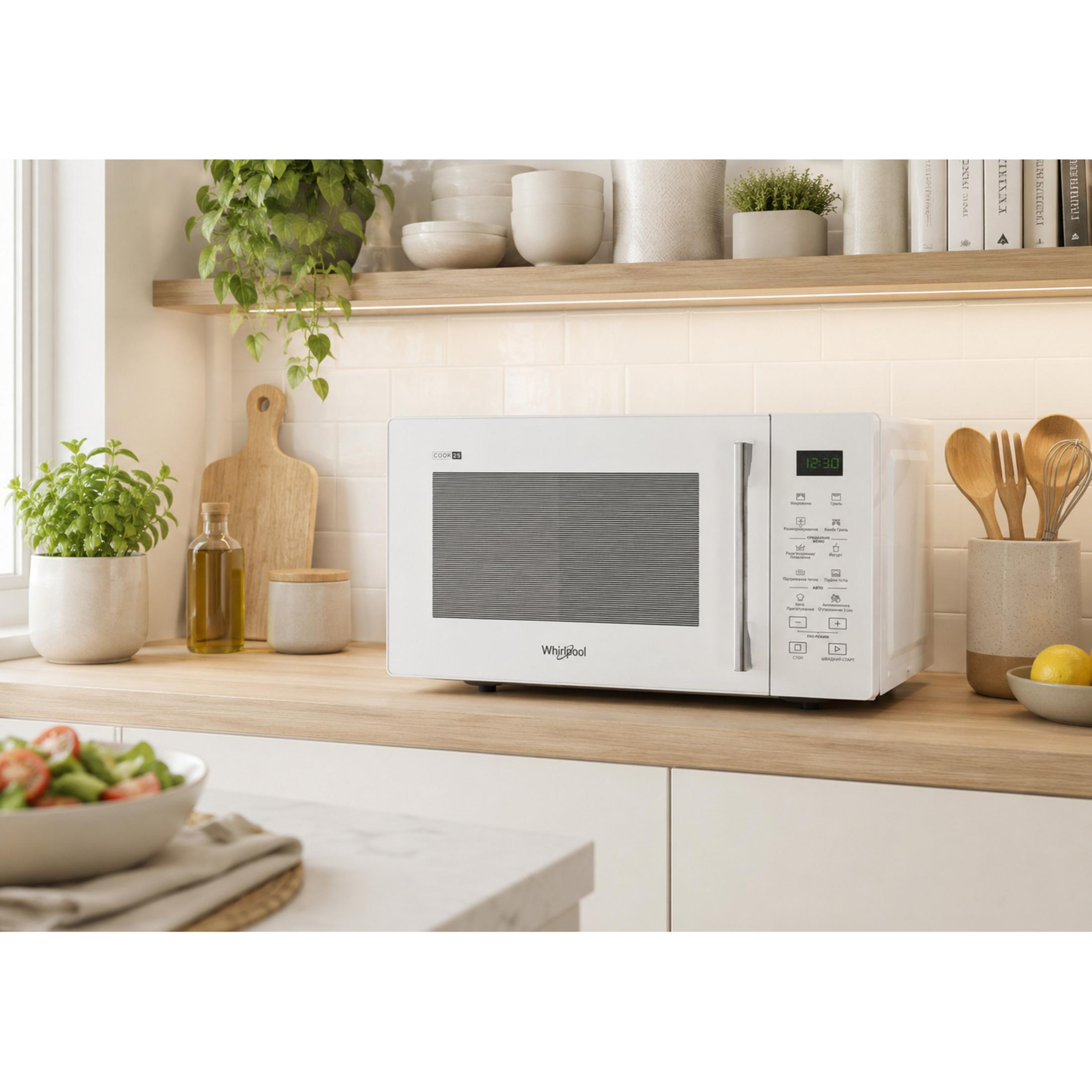 White microwave with control panel and clock on a wooden countertop.