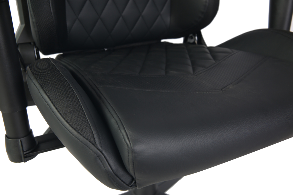 Black gaming chair with quilted faux leather seat and armrests.