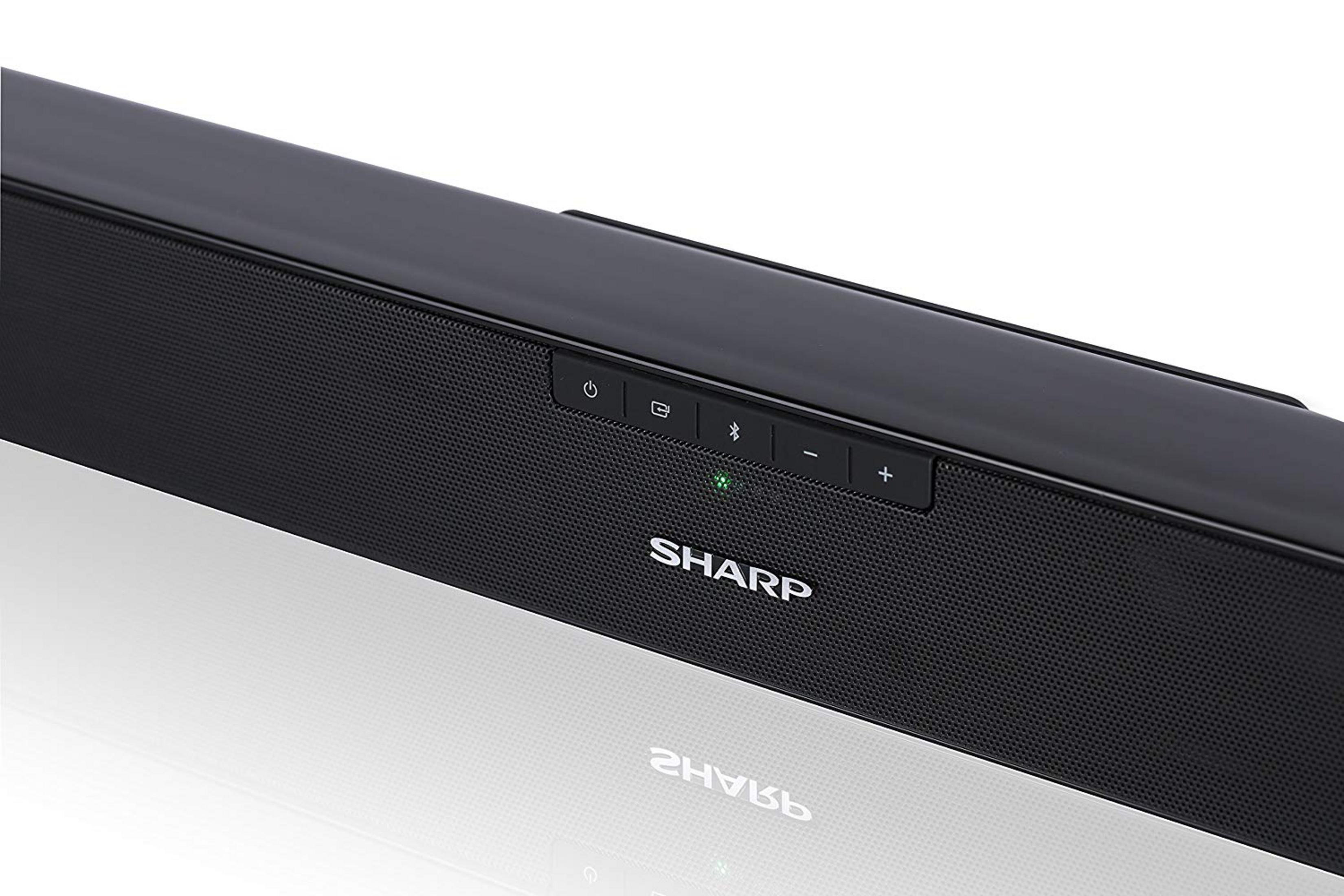 Barra de sonido Sharp negra con botones y luz verde.