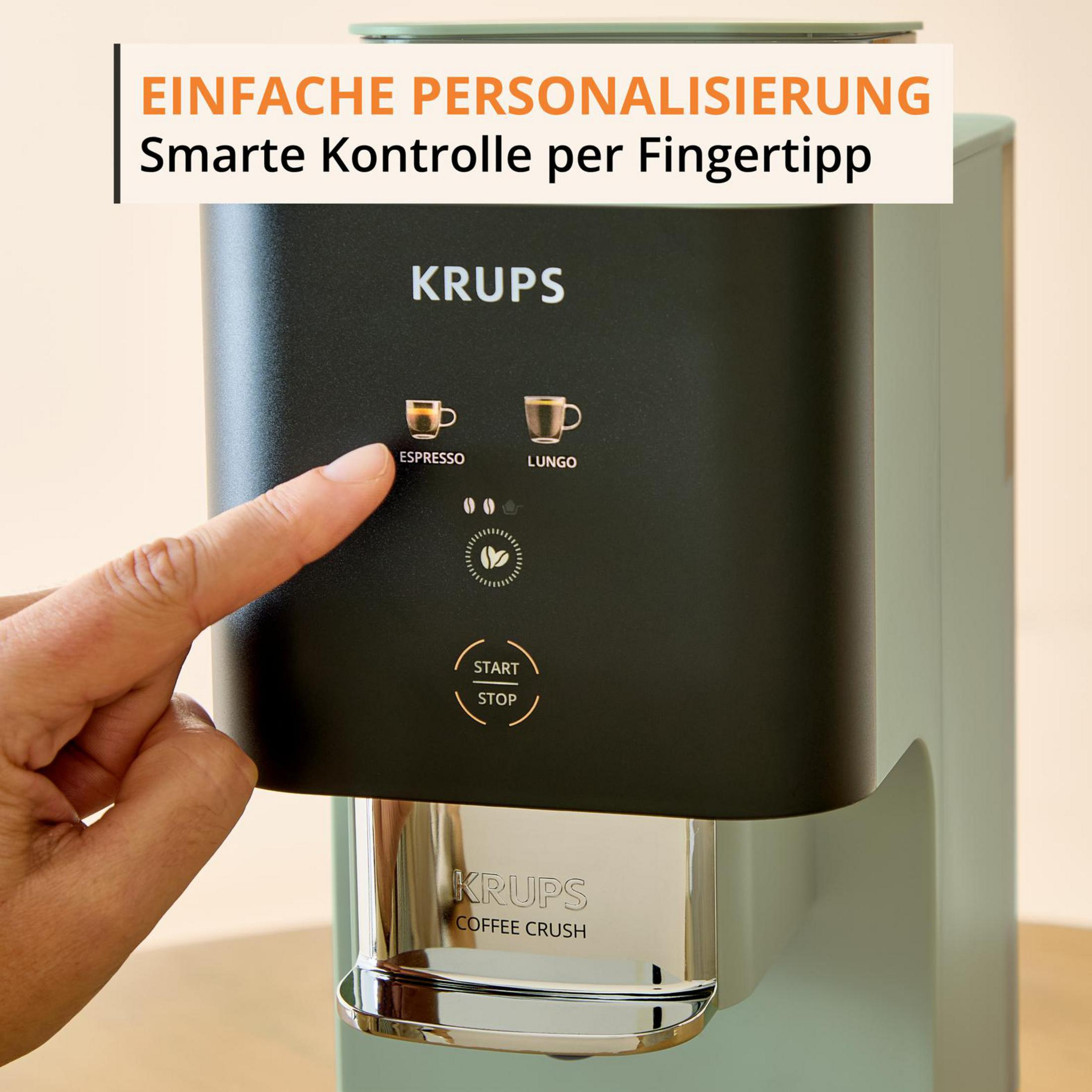Un dito preme il pulsante ESPRESSO di una macchina da caffè Krups.