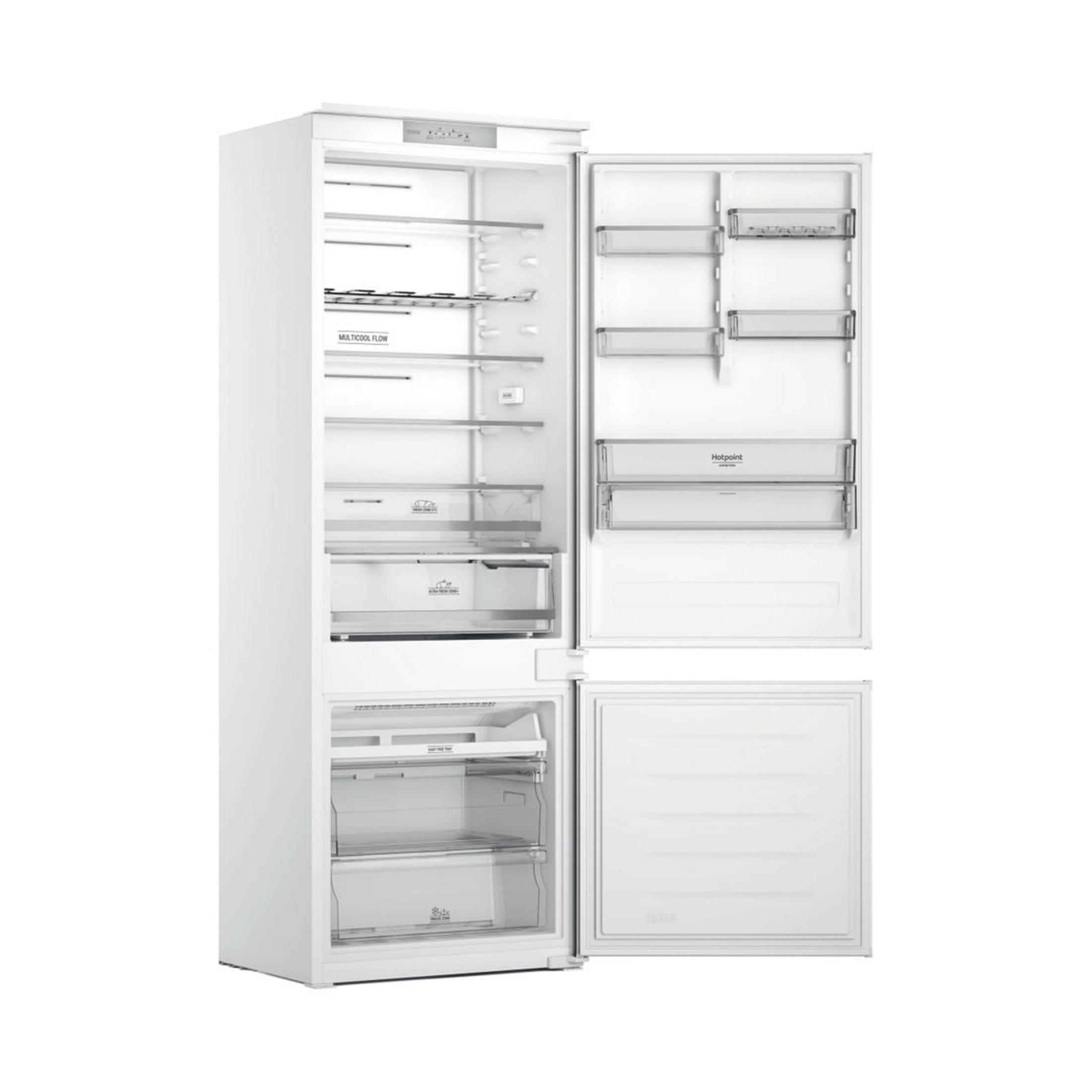 Un frigorífico blanco con la puerta abierta, mostrando estantes y cajones.