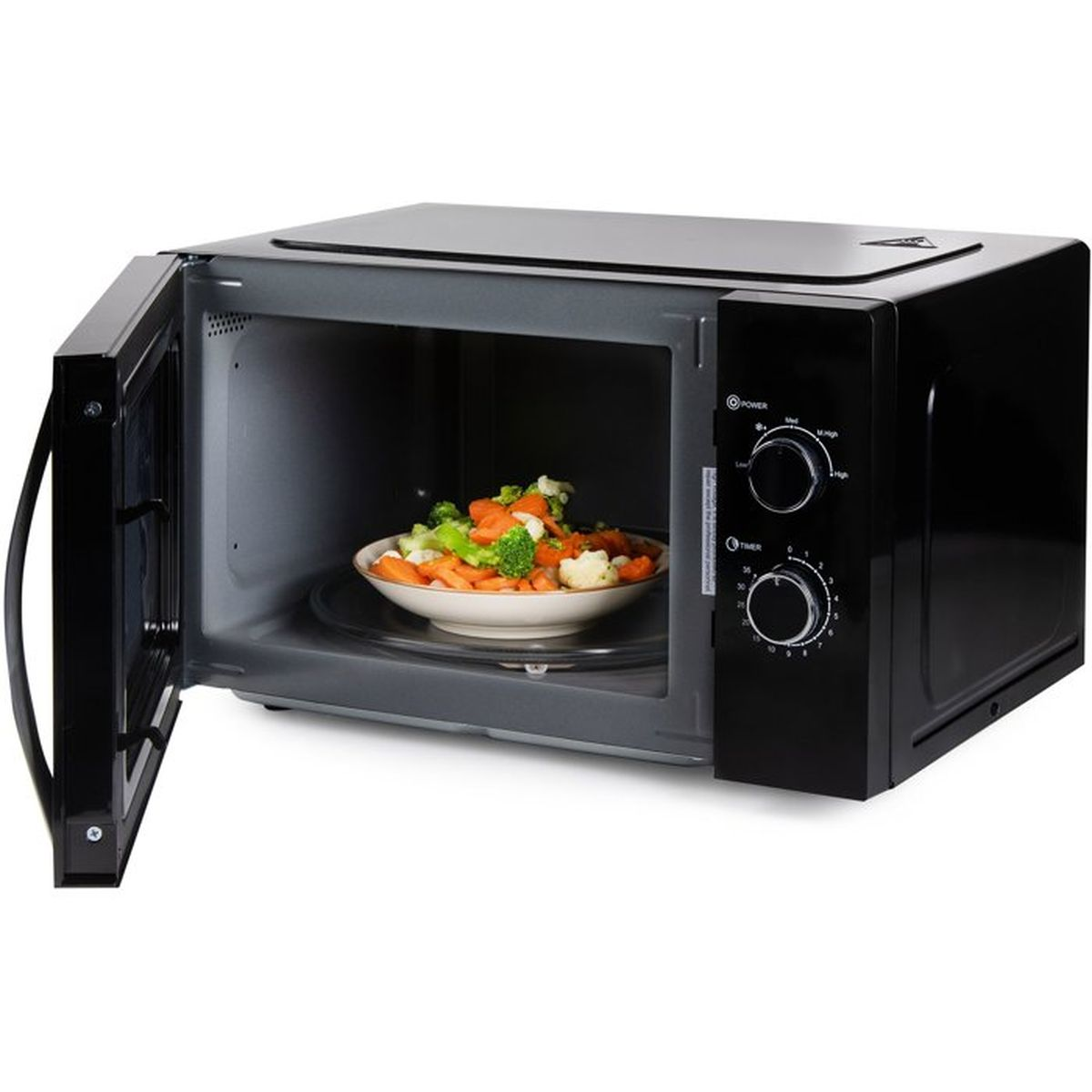 Micro-ondes noir avec porte ouverte, contenant un bol de légumes vapeur.