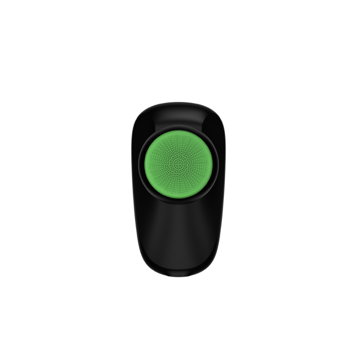 Dispositivo negro con superficie de cepillo redonda y verde, visto desde arriba.