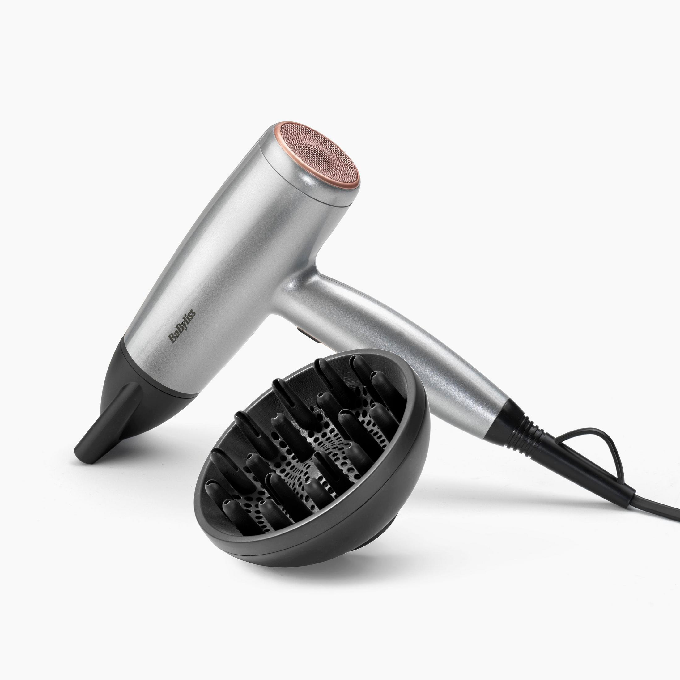 Silver hairdryer with black diffuser and copper-colored grille.