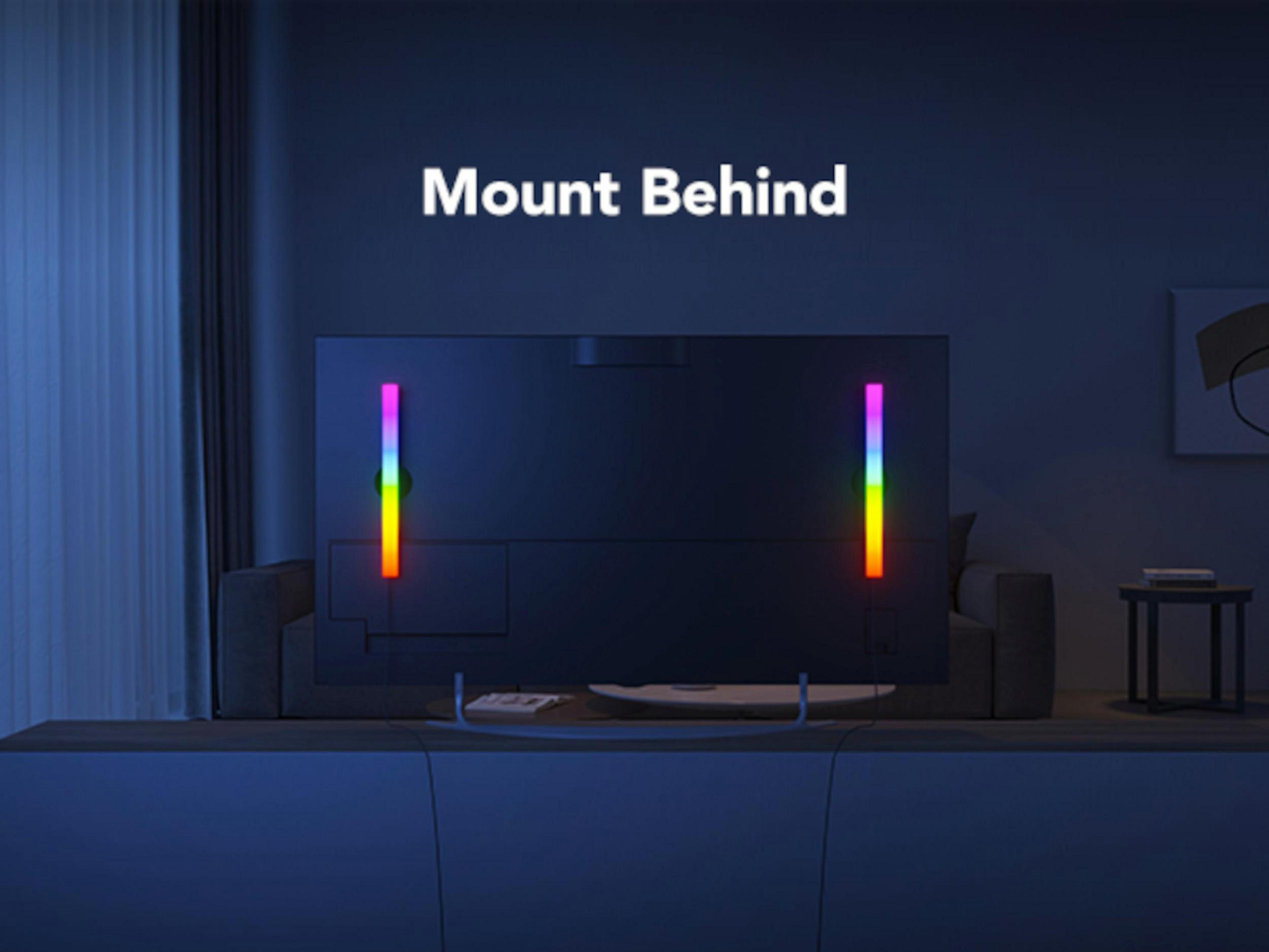 Een tv met kleurrijke lichten aan de achterkant staat op een kast. Tekst: Mount Behind.