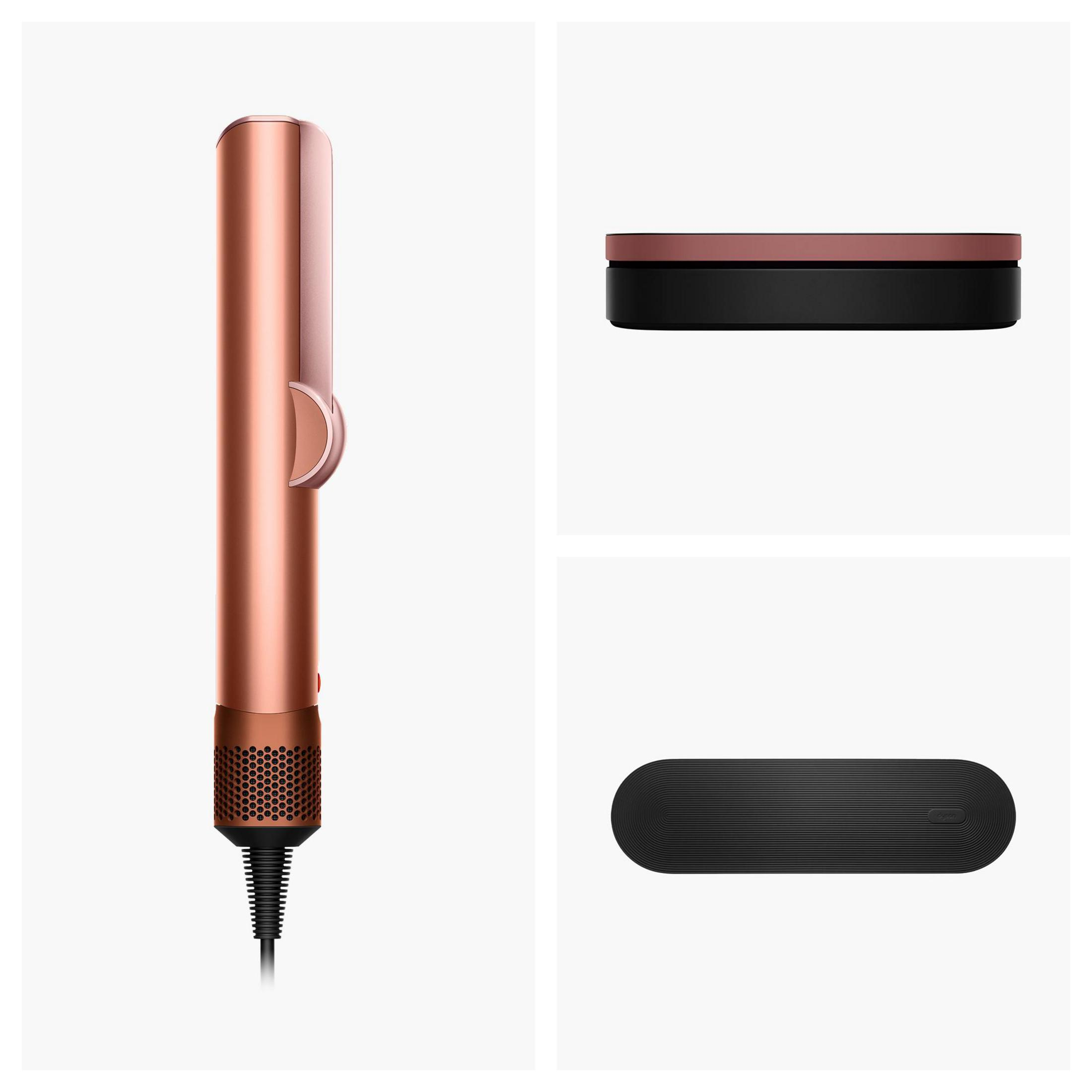 Ein roségoldener Haartrockner mit schwarzem Kabel und Zubehörteilen.