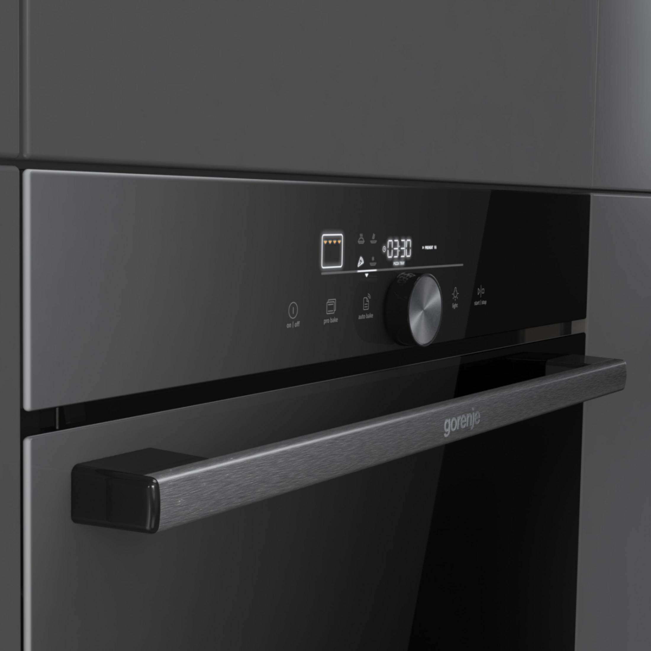 Un moderno forno nero con display digitale, manopola e maniglia.