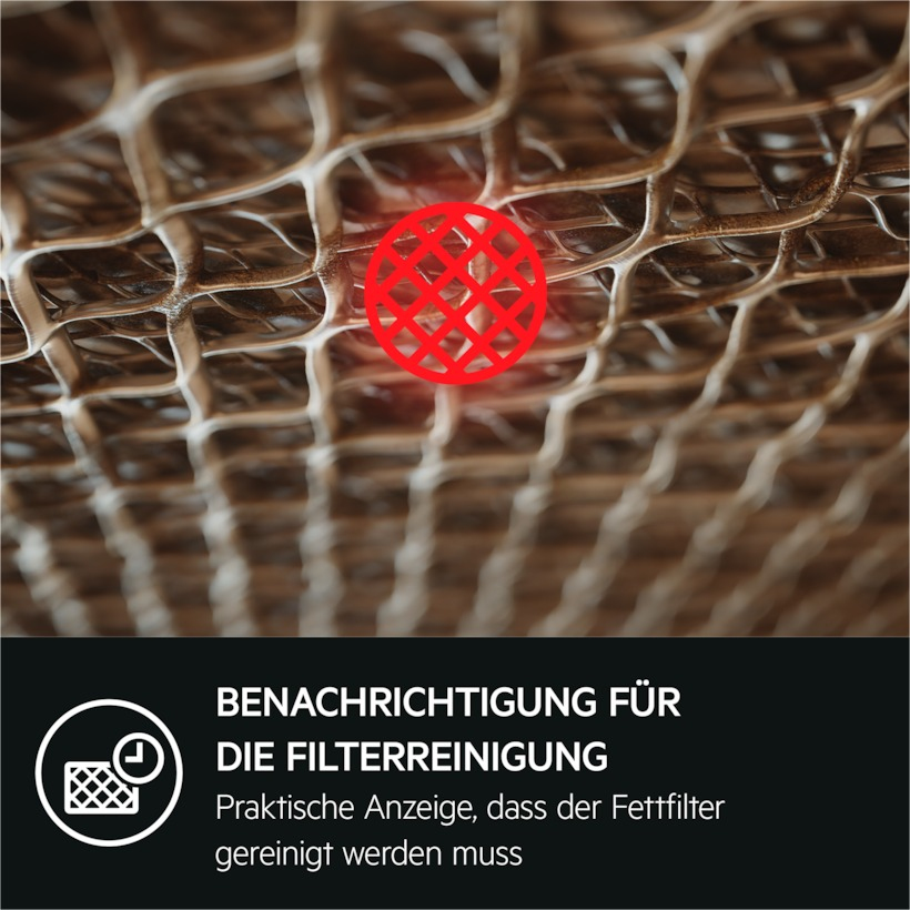 Detailaufnahme eines Fettfilters mit rotem Hinweis und Text 'Filterreinigung'.