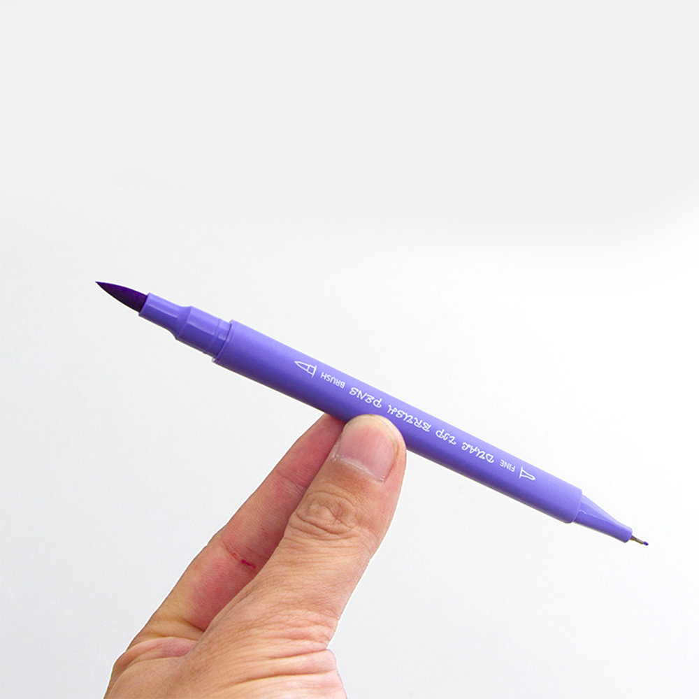 Una mano tiene un pennarello a pennello viola a punta fine.