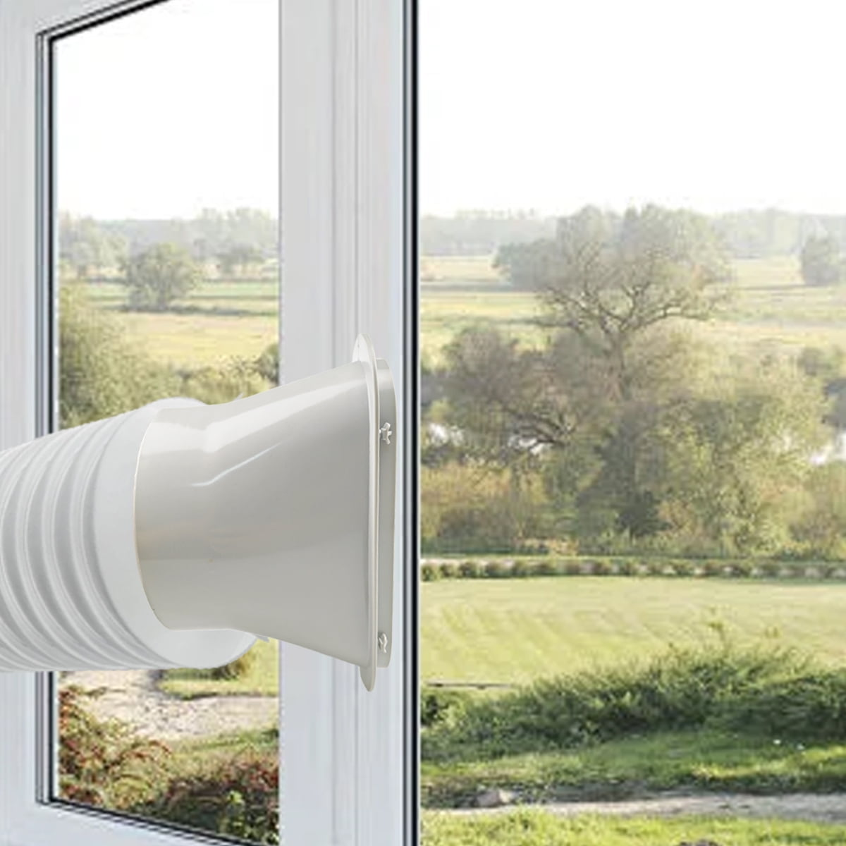 Weißer Lüftungsschlauch an einem Fensterrahmen, draußen grüne Landschaft.