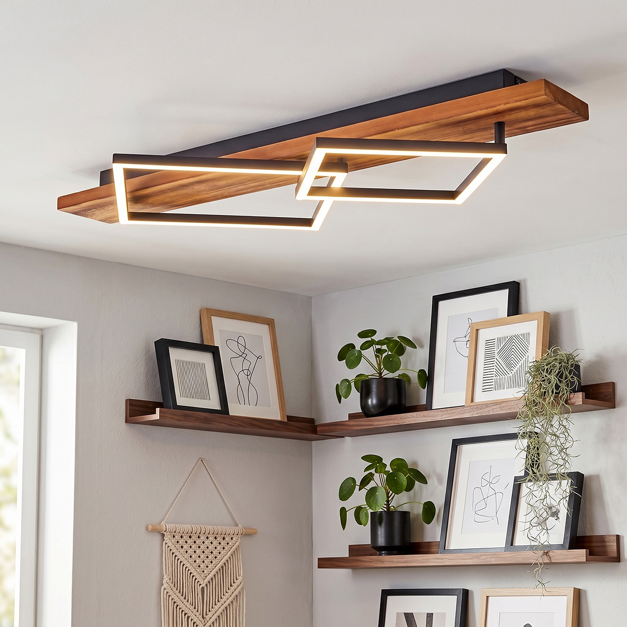 Moderne Deckenleuchte mit Holz und Metall, kombiniert mit gerahmten Bildern und Pflanzen.