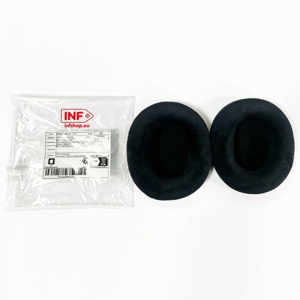 A package of ear pads and two individual black ear pads on a white surface.