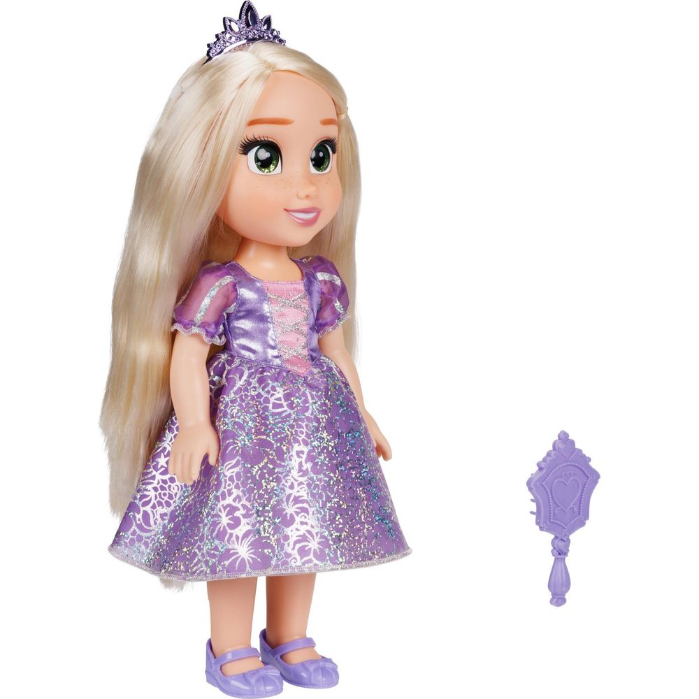 Una muñeca de pelo rubio largo lleva un vestido morado y corona. Un espejo al lado.