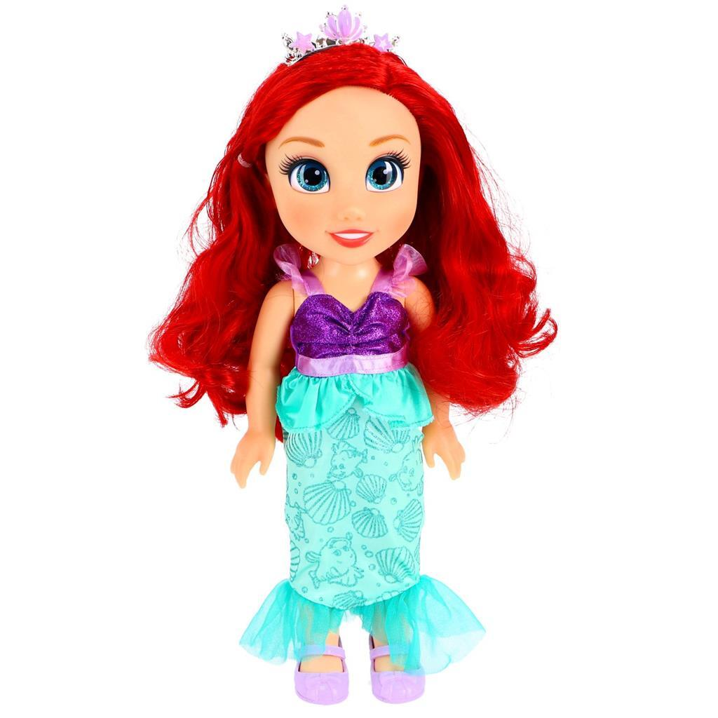 Muñeca de sirena con pelo rojo, tiara, top morado y falda de conchas.