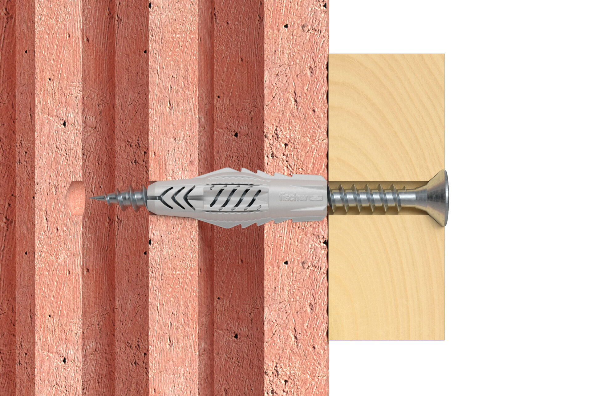Ein Dübel mit Schraube in Ziegelwand und Holzbrettern.