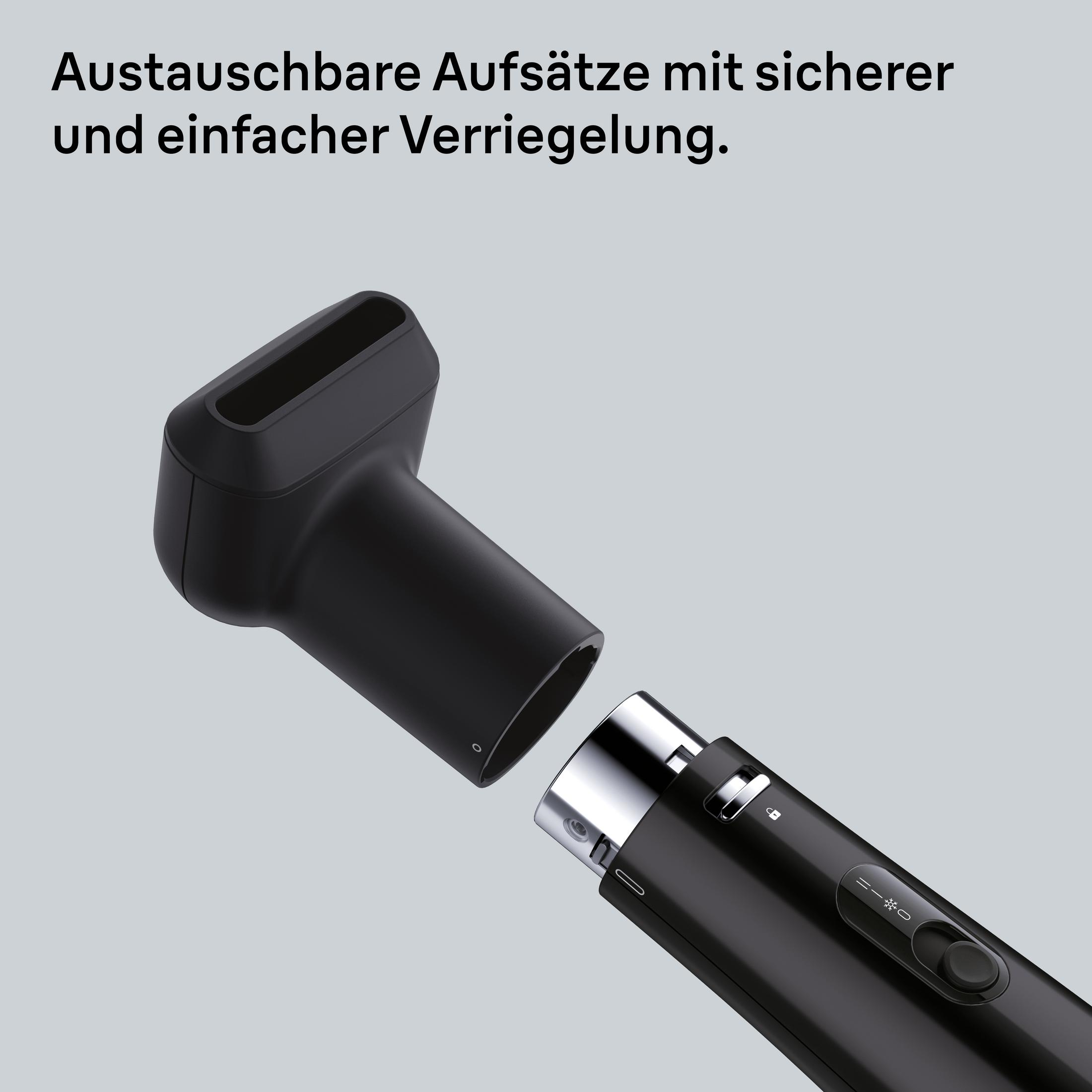 Ein schwarzer Haartrockneraufsatz wird an den Hauptkörper des Haartrockners angesteckt.