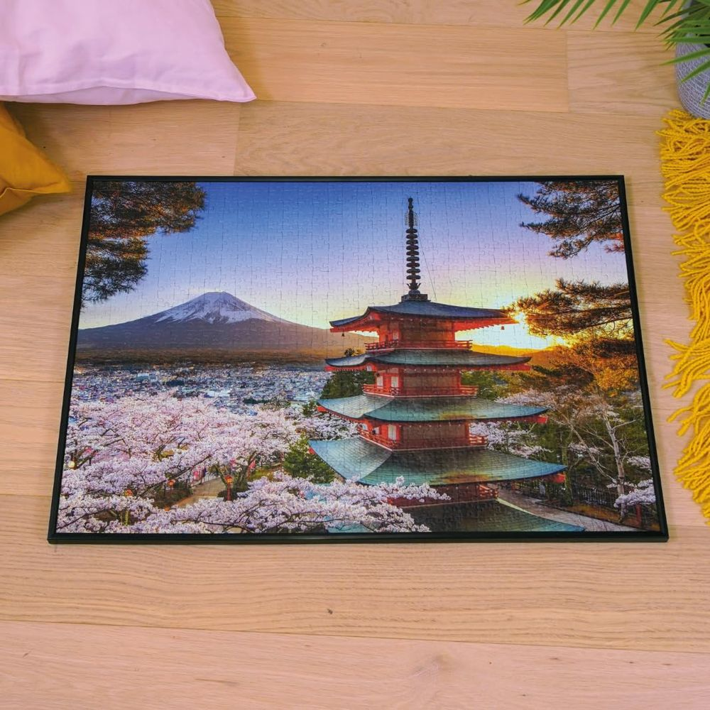 Eine Pagode und der Fuji bei Sonnenuntergang mit blühenden Kirschbäumen.