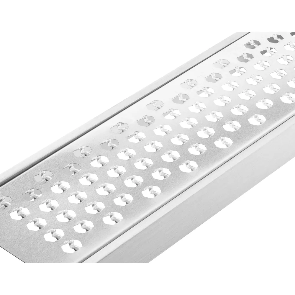 Nahaufnahme eines Metallreibe mit kleinen, sechseckigen Löchern und einem silbernen Griff.