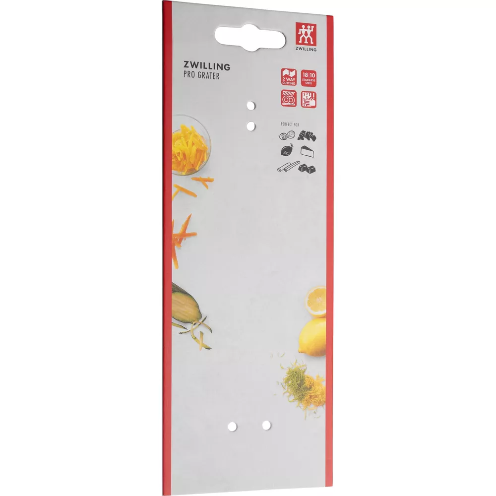Verpackung für ZWILLING PRO GRATER mit Bildern von geriebenem Käse, Karotten, Zitrone.