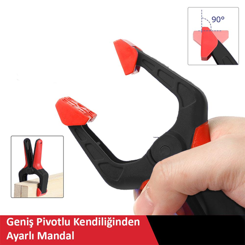 Siyah ve kırmızı bir mandal elle tutuluyor, küçük bir alanda tahta parçaları gösteriliyor.