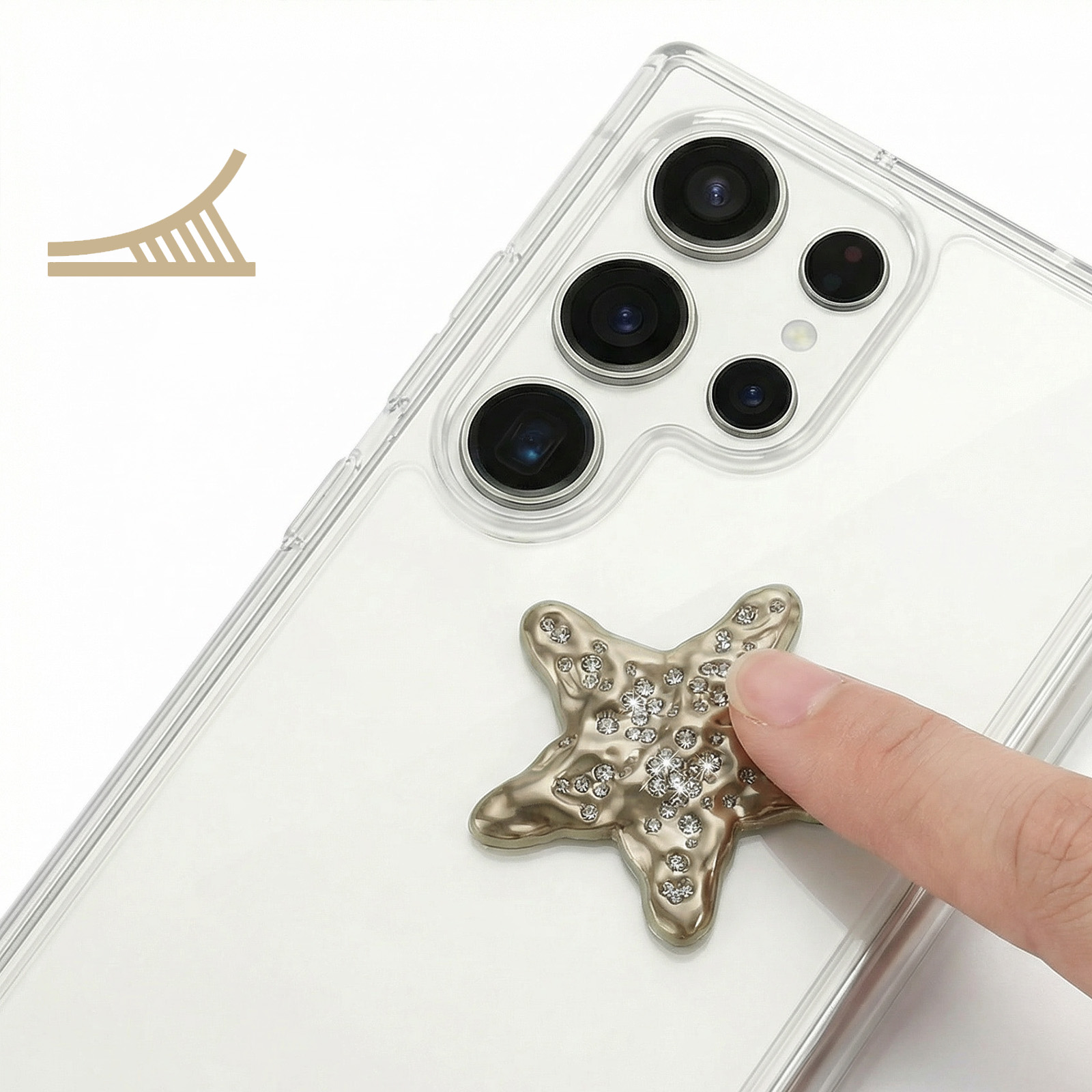 Ein finger drückt auf einen sternförmigen Handy-Aufkleber mit Kristallen auf einem durchsichtigen Handy.
