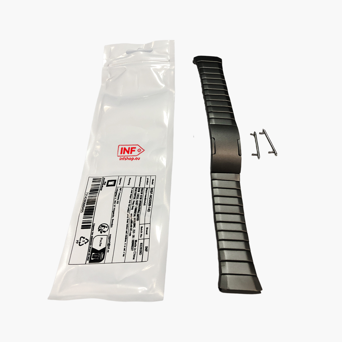 Ein graues Metallarmband mit Verpackung und zwei Stiften auf weißem Hintergrund.