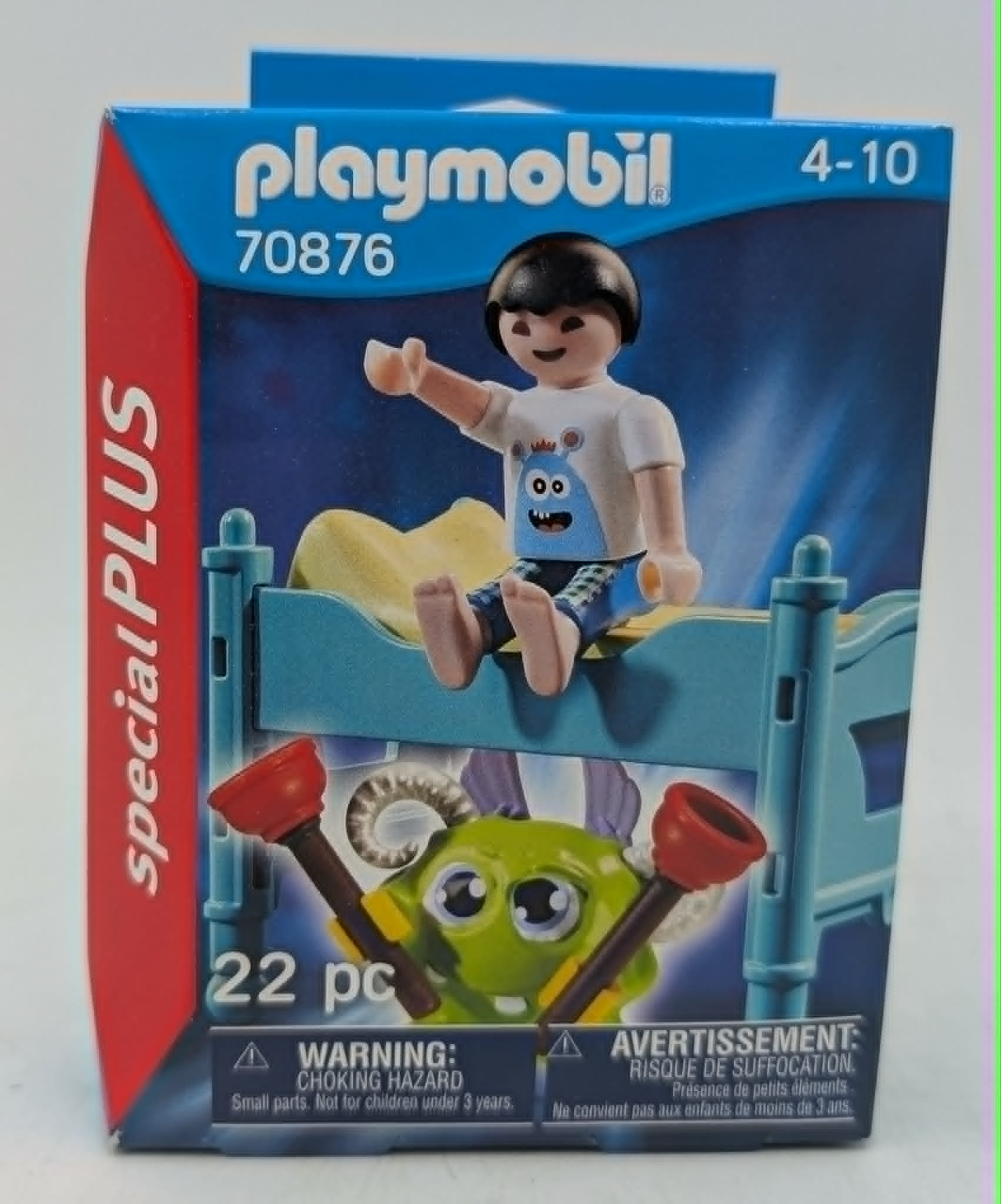 Caja de juguetes Playmobil con figura en cama, monstruo y advertencia de piezas pequeñas.