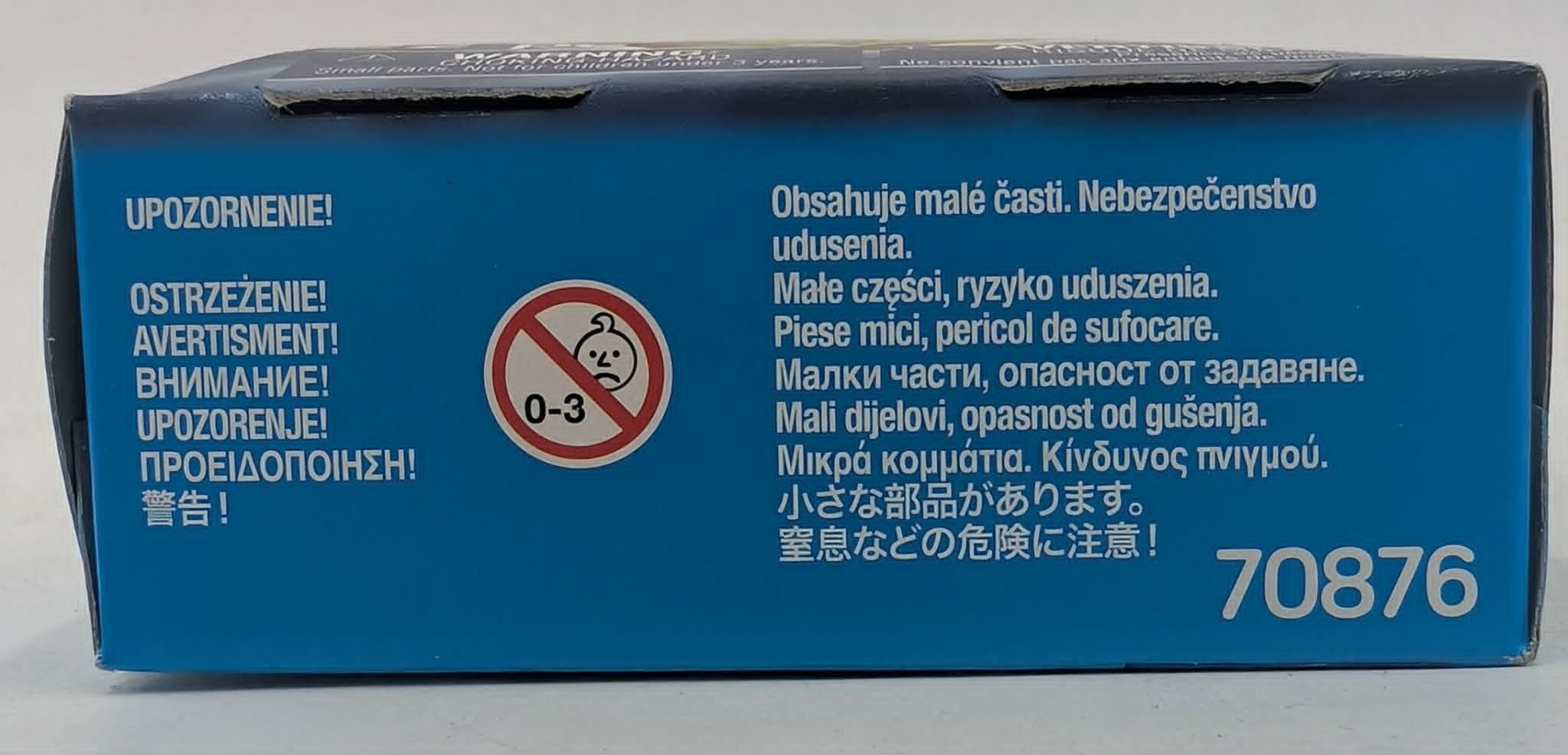 Caja azul con advertencias multilingües y un símbolo 0-3.
