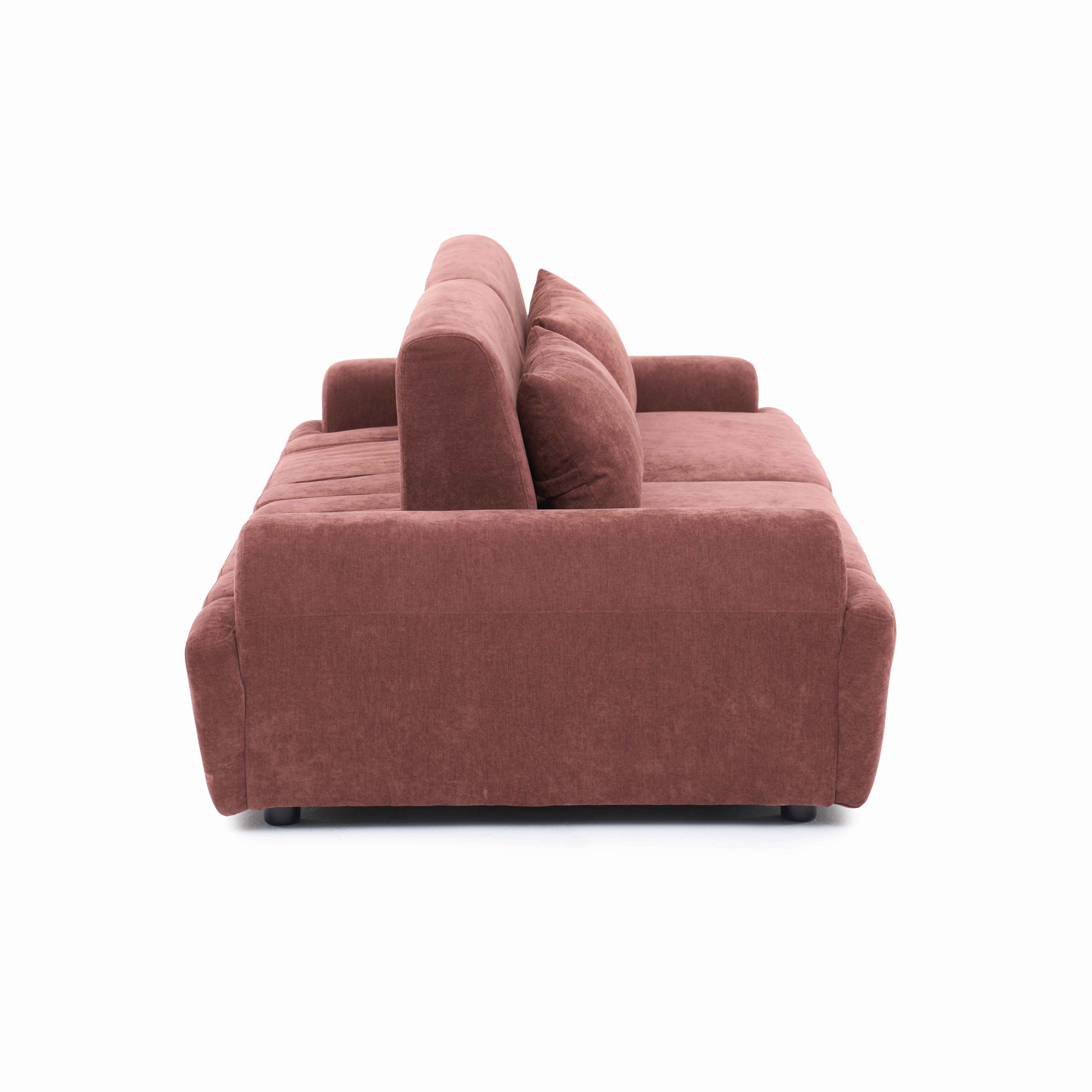 Ein brauner Stoffsofa mit zwei Kissen, von der Seite gesehen.