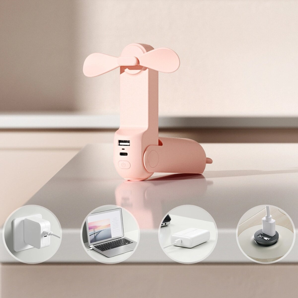 Ventilatore portatile rosa con porte USB, mostrato con accessori di ricarica.