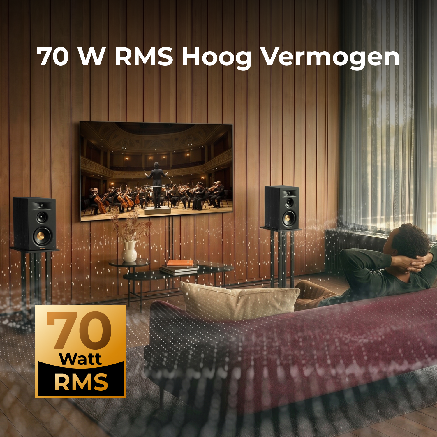 Een man ontspant zich op een bank terwijl twee luidsprekers muziek afspelen.