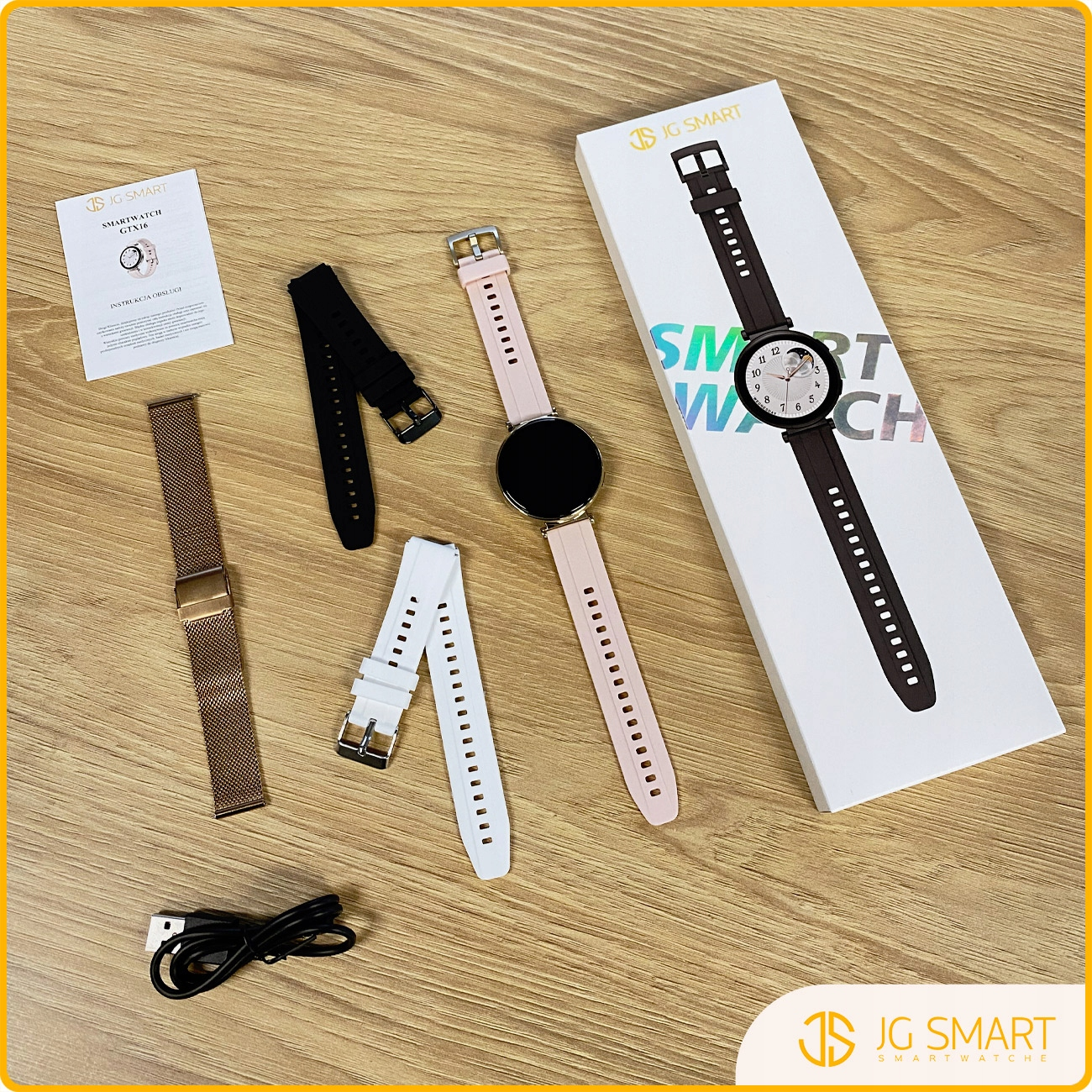 Smartwatch z różowym paskiem, zapasowe paski, kabel ładujący i instrukcja.
